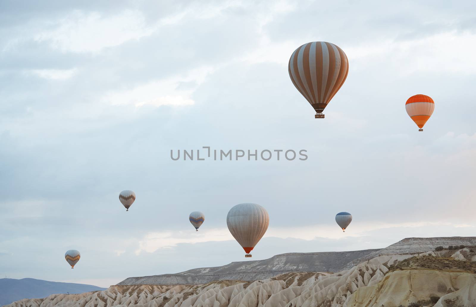 Hot air balloons flying over the rocks of Cappadocia, Turkey