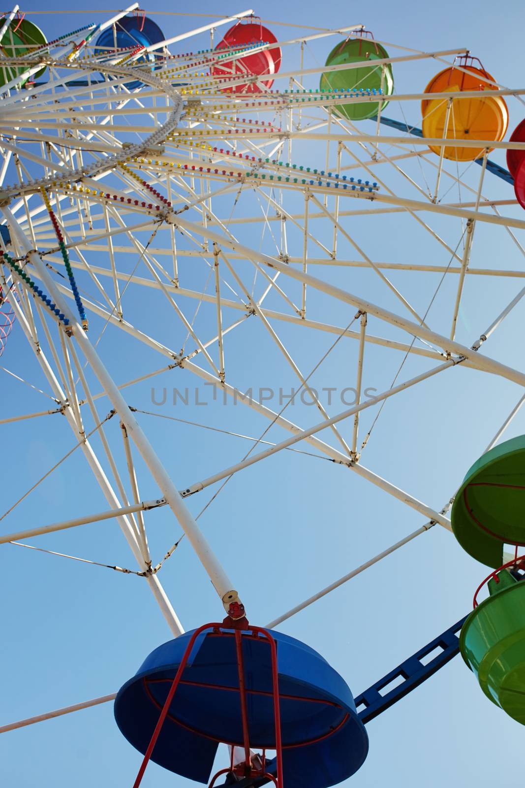 Ferris wheel in public amusement park. Low angle view