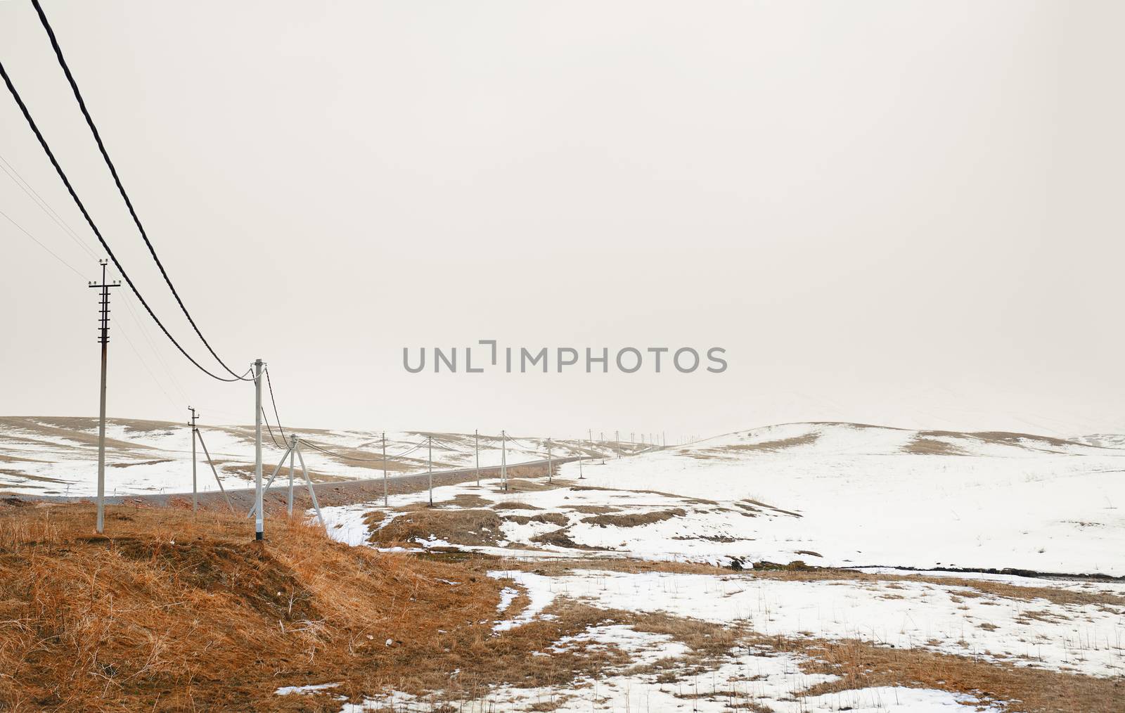 Winter field with power line columns