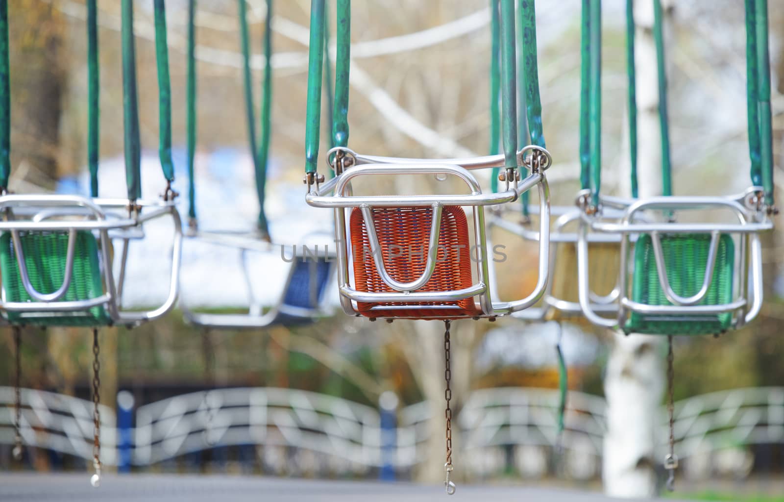 Empty chain swing in amuzement park by Novic