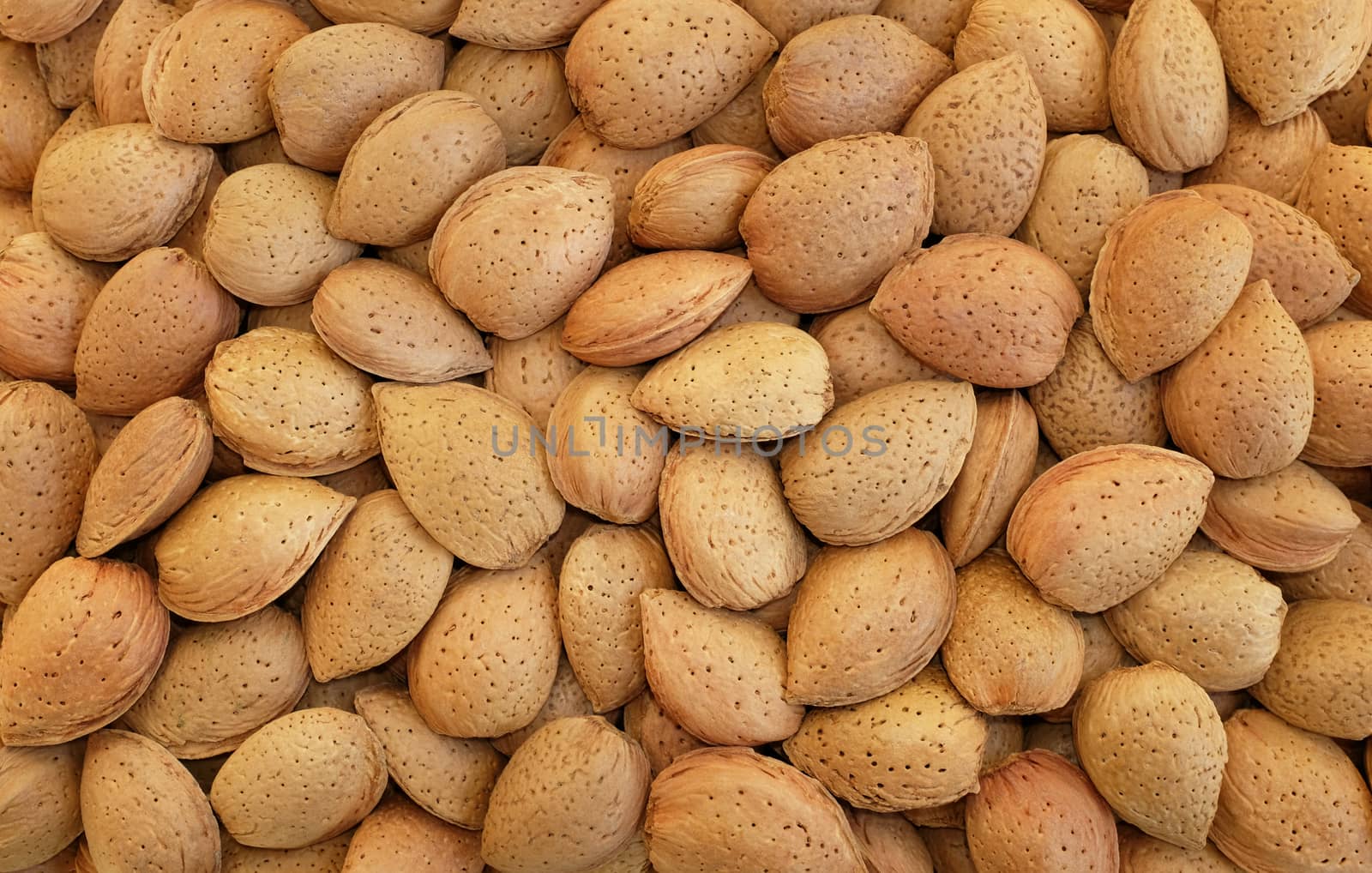 Whole almonds in shells as an abstract background texture