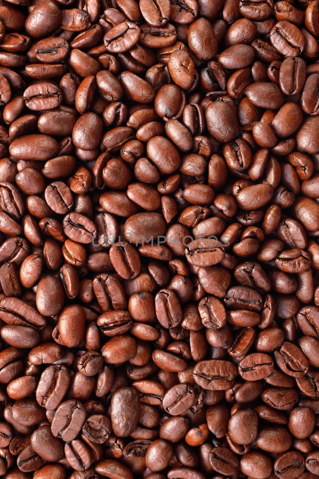Dark roasted coffee beans as an abstract background texture