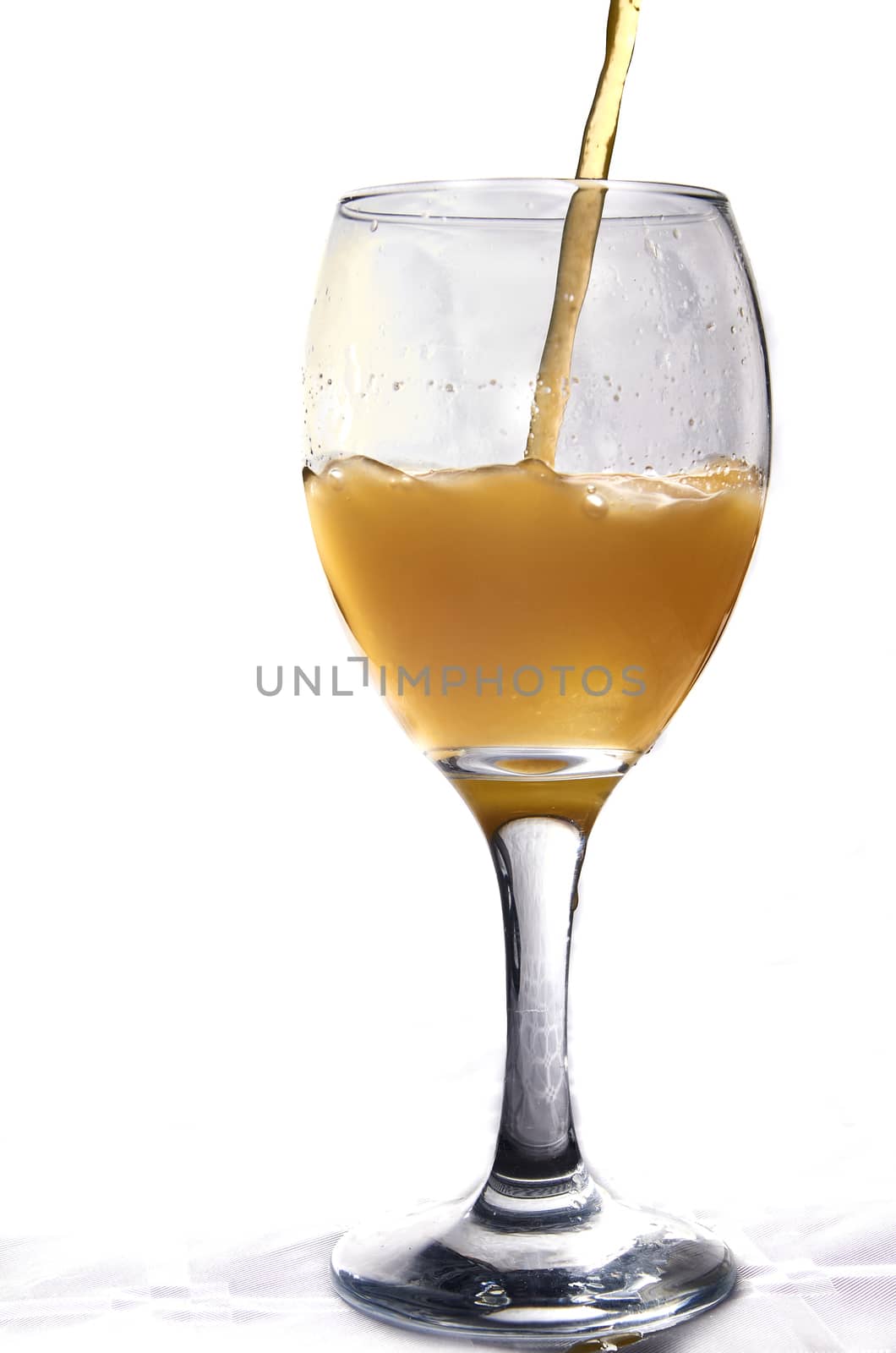 Natural orange juice from Valencia falling inside a glass cup