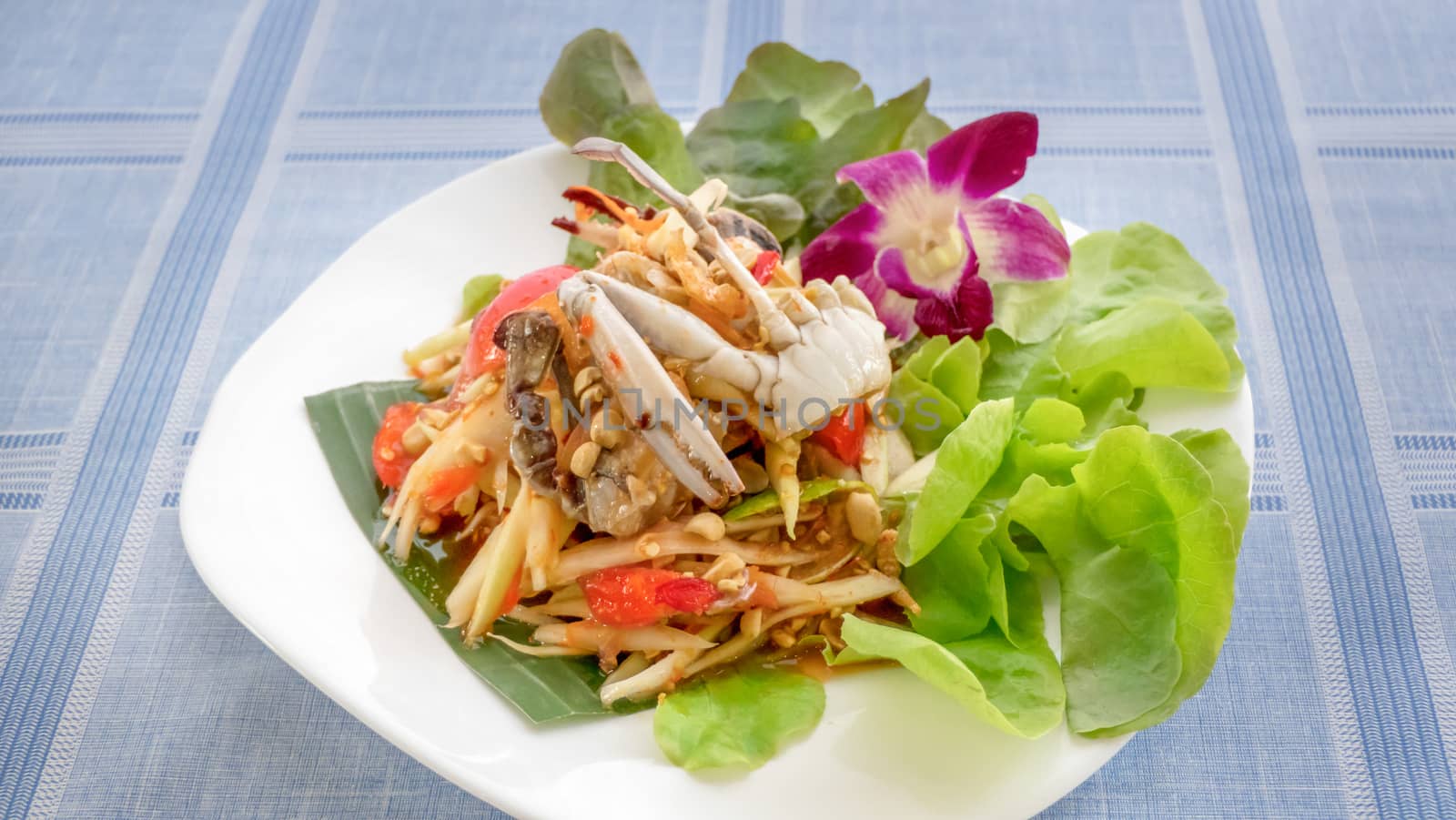 Traditional thai cuisine spicy green papaya salad with crab