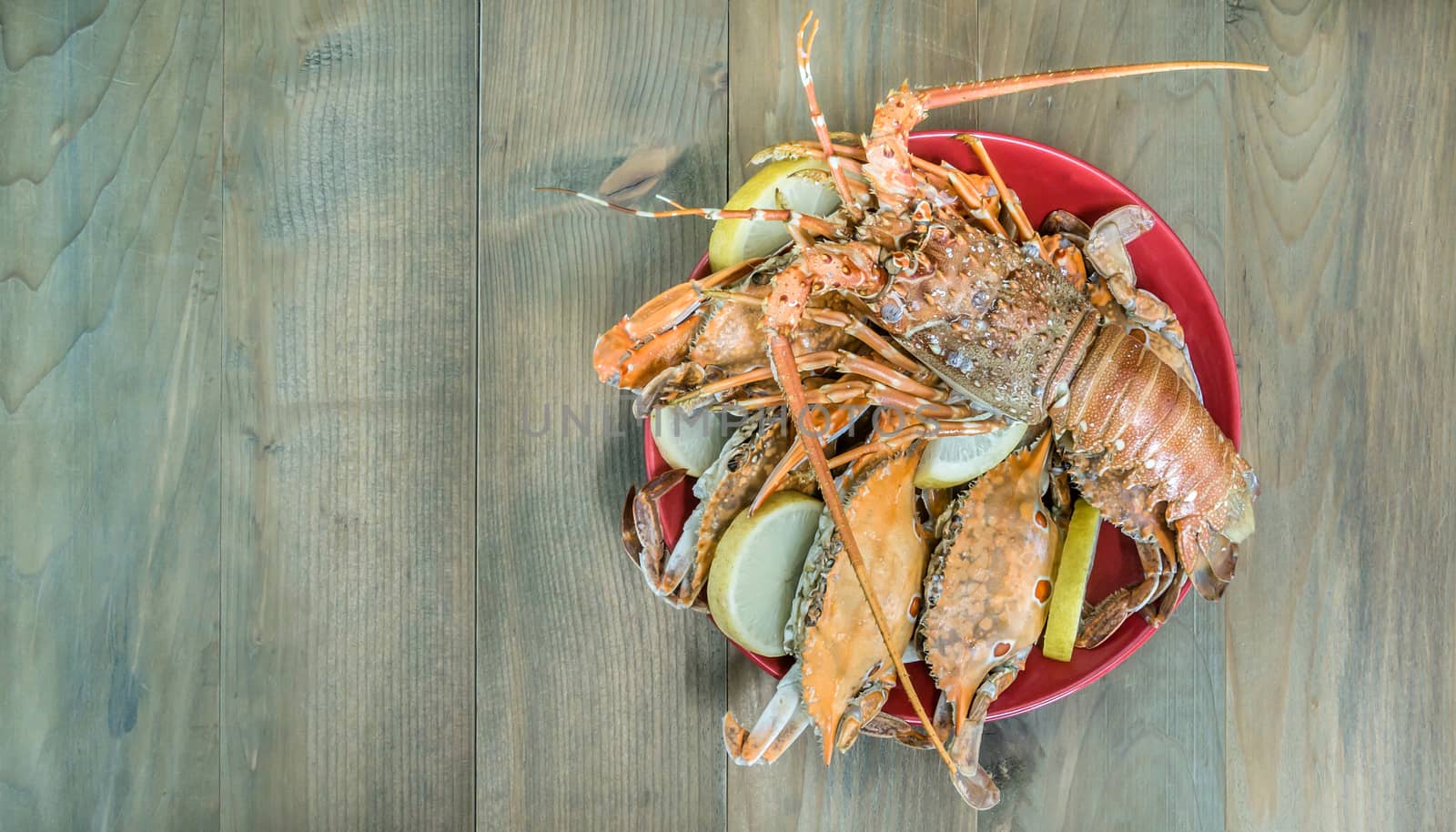 top view of steamed lobster and crab on plate