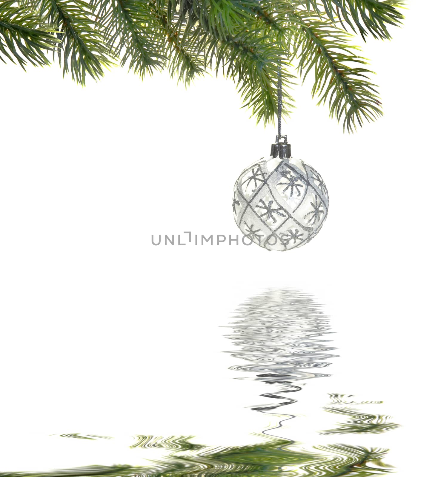 Christmas ball on a fir branch isolated on white background reflected in the water surface with small waves