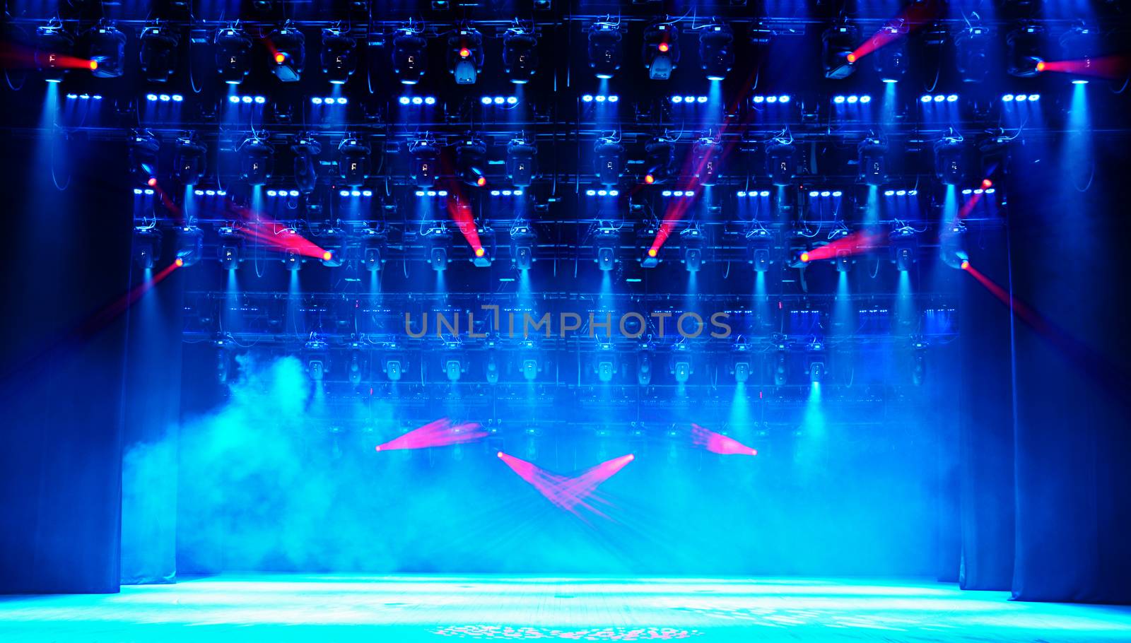 Illuminated empty concert stage with scenic fog