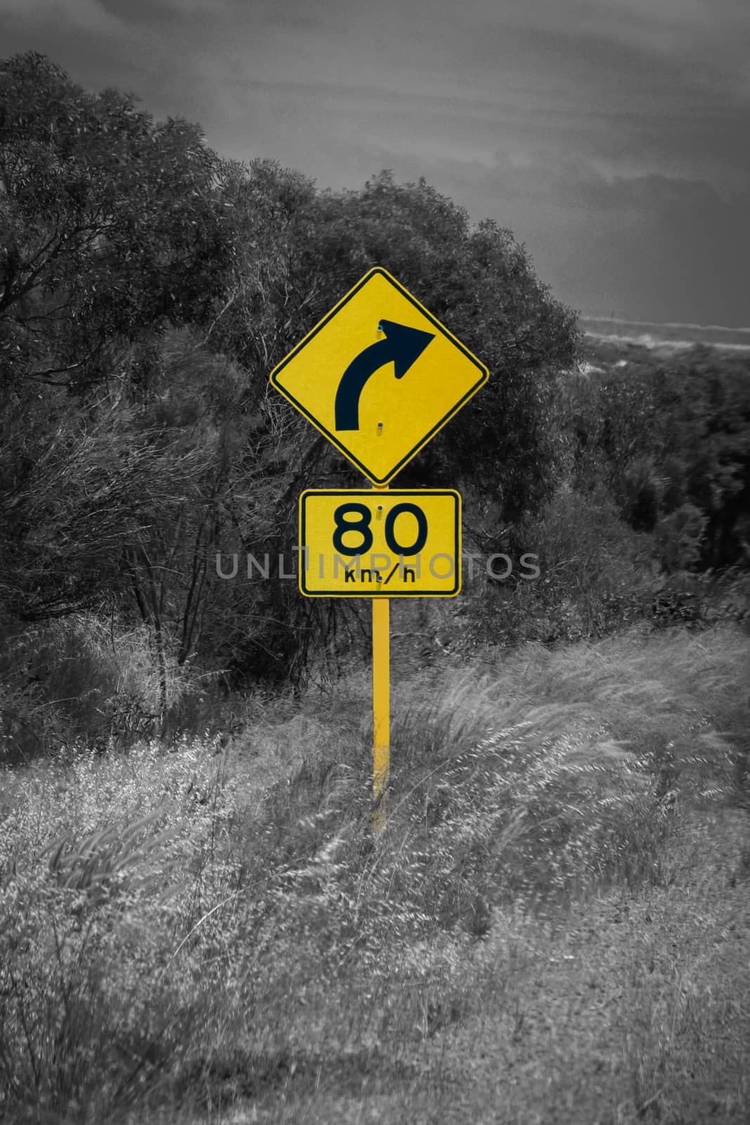 Street sign in Australia warning right curve ahead speed 80 in black and white with yellow accent color by MXW_Stock