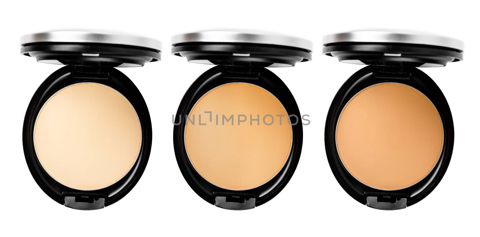 Collection of powder foundation makeup different shades compact on white background.