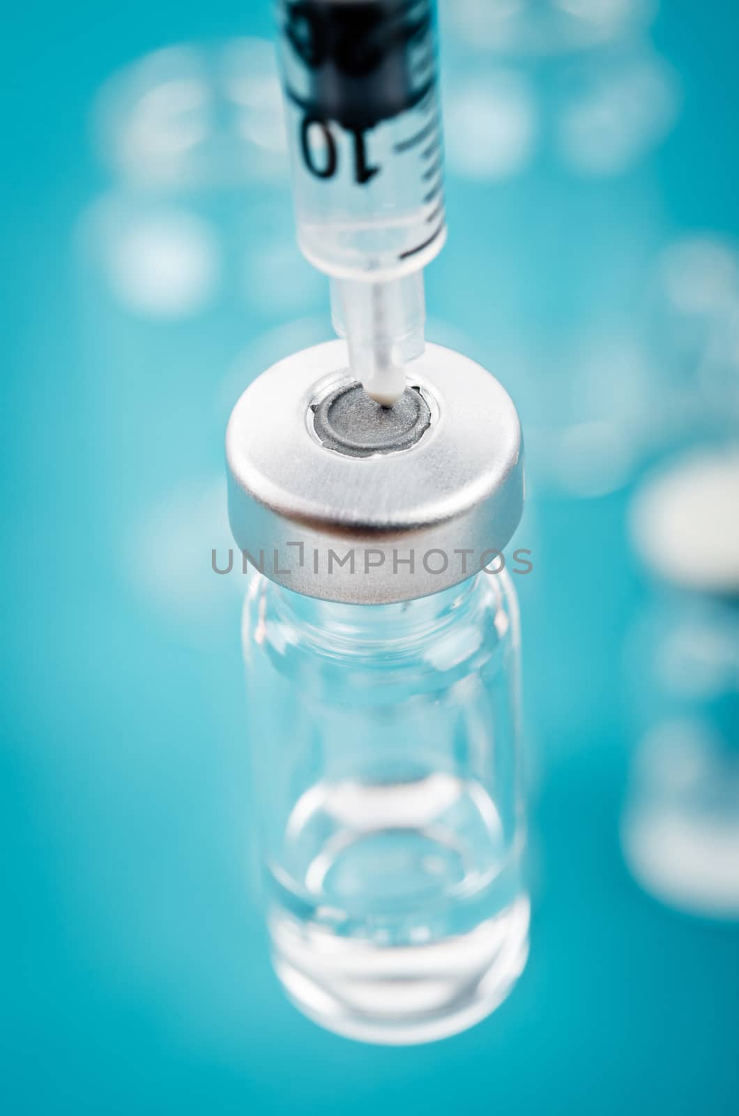 Vaccine vial dose with needle syringe. by Gamjai