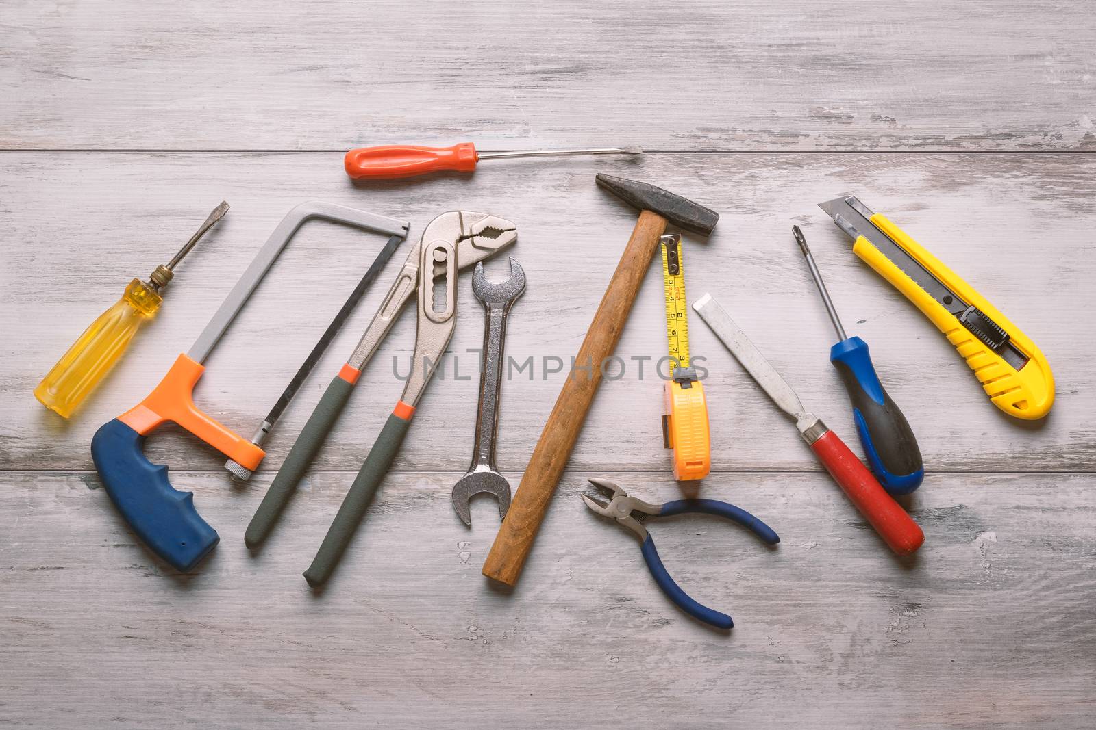 Screwdriver,hammer,tape measure and other tool for construction tools on gray wooden background with copy space,industry engineer tool concept.still-life.