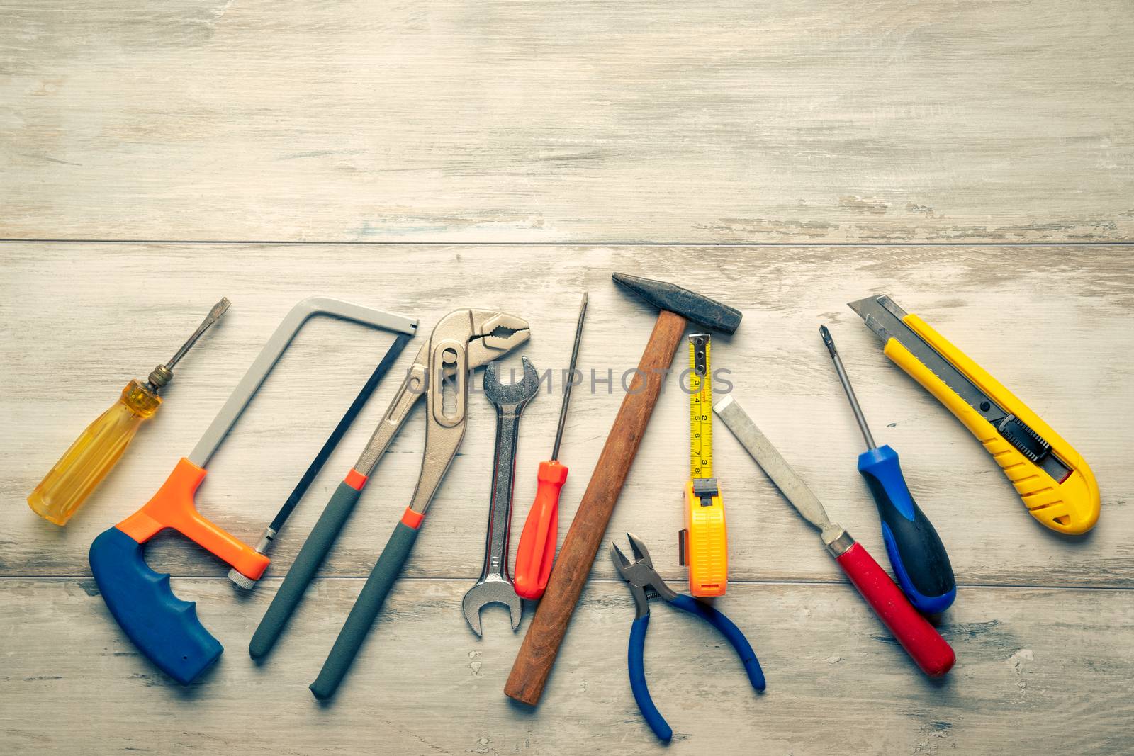 Screwdriver,hammer,tape measure and other tool for construction tools on gray wooden background with copy space,industry engineer tool concept.still-life.