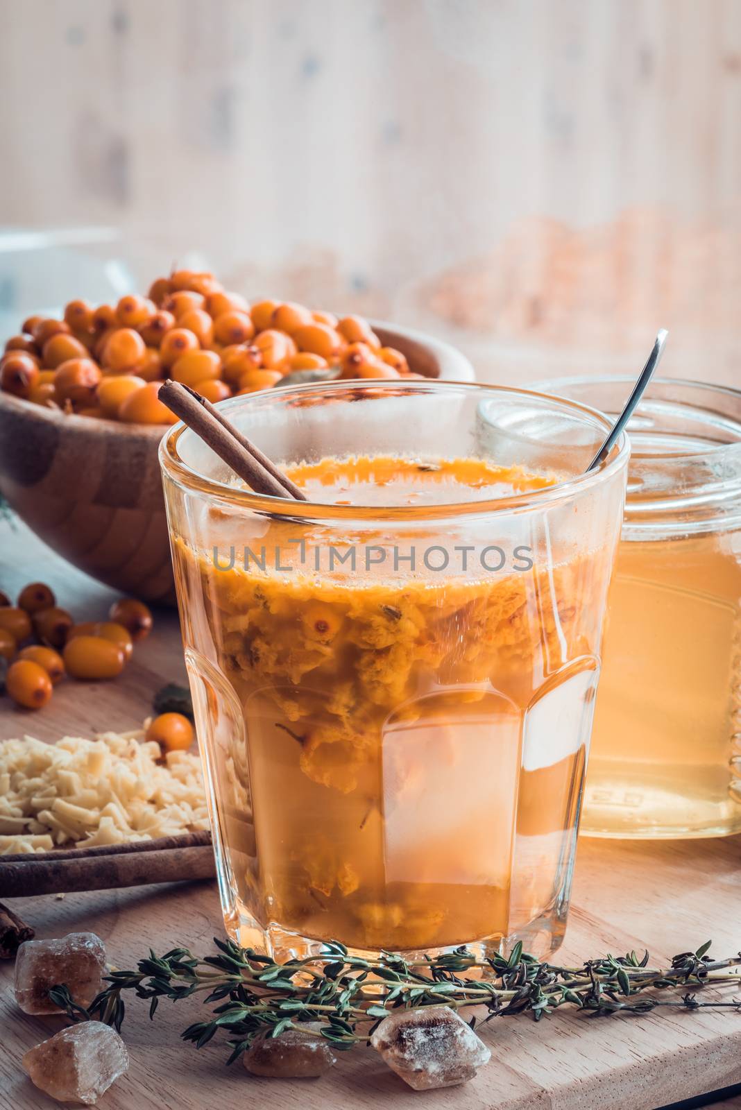sea buckthorn honey ginger mix in glass with ingredients. Sweet cocktail