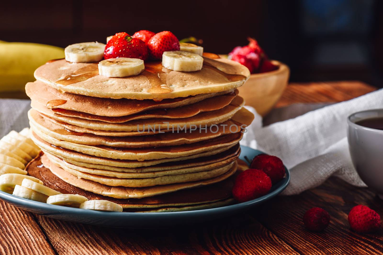 Homemade Pancakes with Fruits. Sliced Banana and Frozen Strawberry.