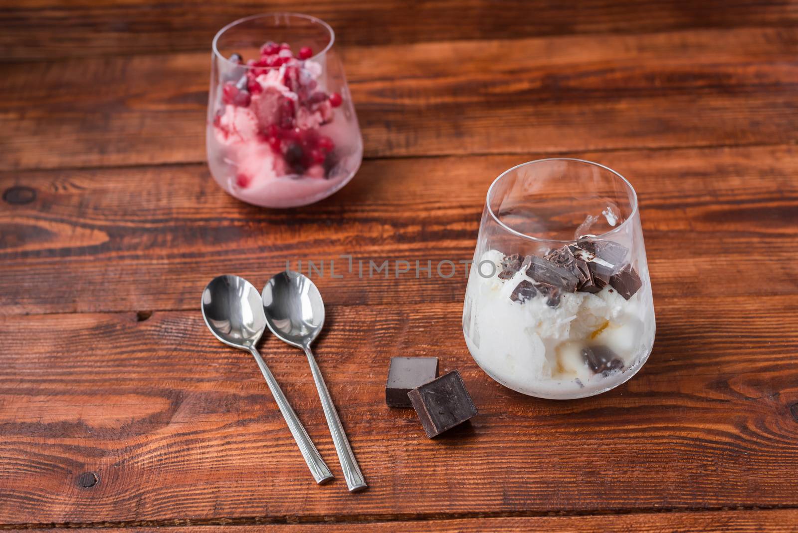 Sweet desert with ice cream, chocolate and berries in glass