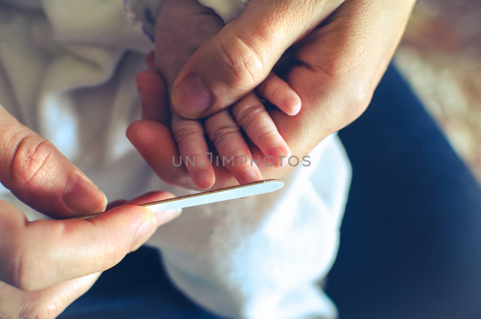 filing nails of newborn to avoid scratches - baby nail file cut