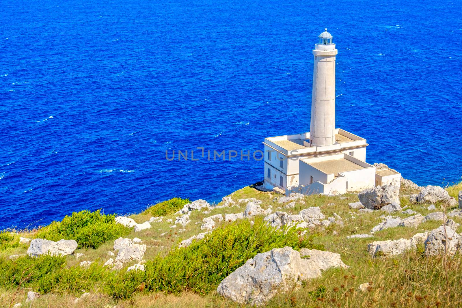 white lighthouse cliff overlook seascape daytime Punta Palascia Otranto Salento Italy by LucaLorenzelli