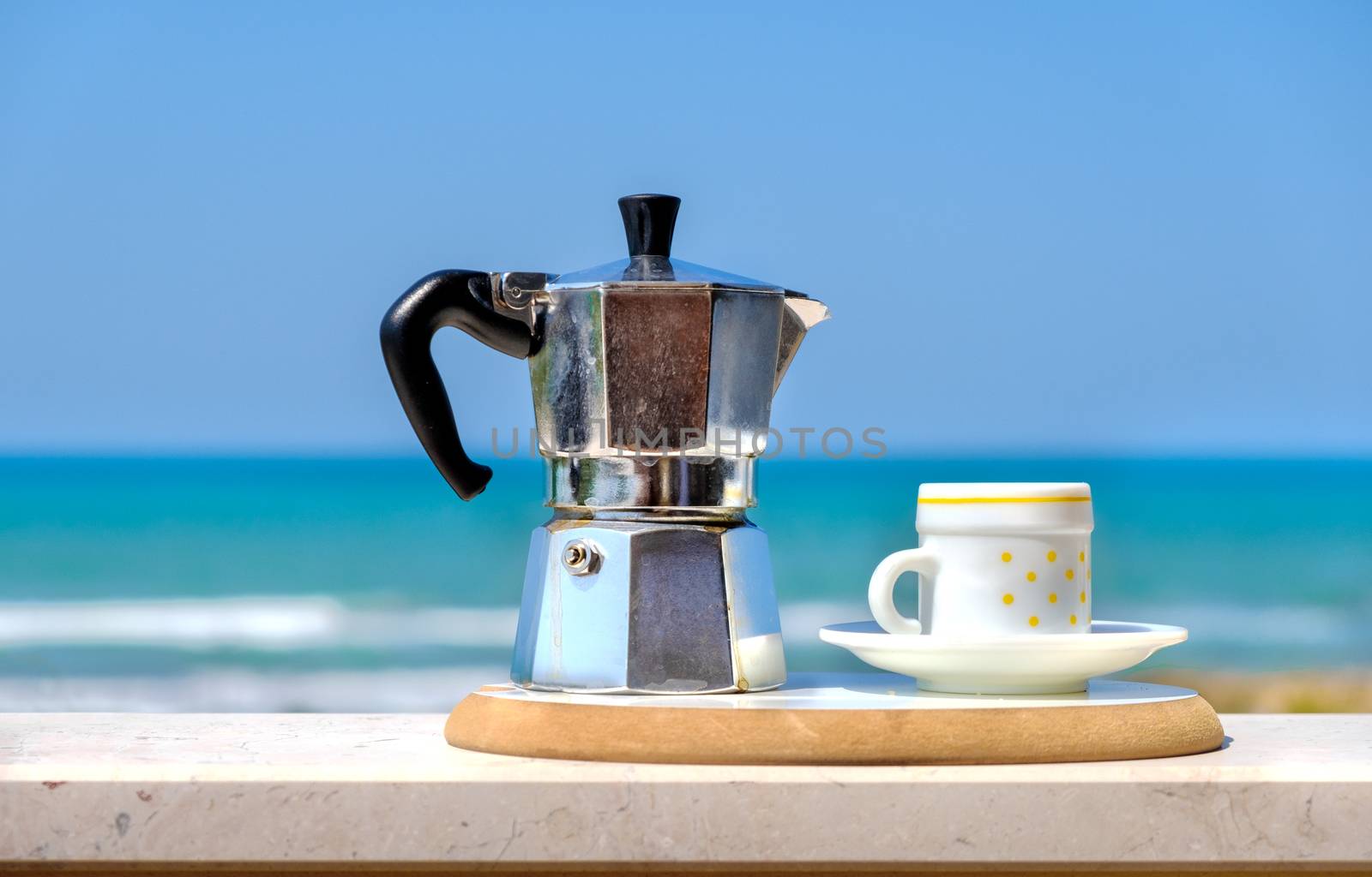 moka pot coffee maker sea background italian breakfast .