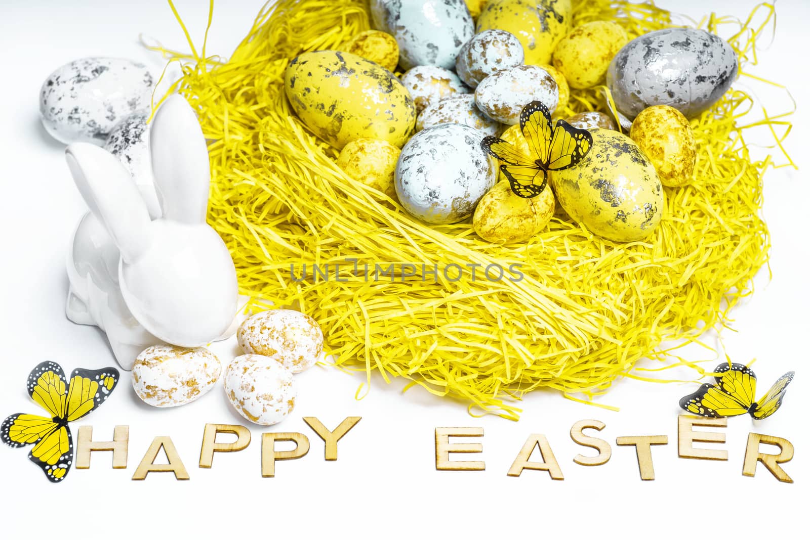 Happy Easter. Easter white bunny on a white background with Easter eggs.Easter greeting card with easter bunny.Happy Easter.