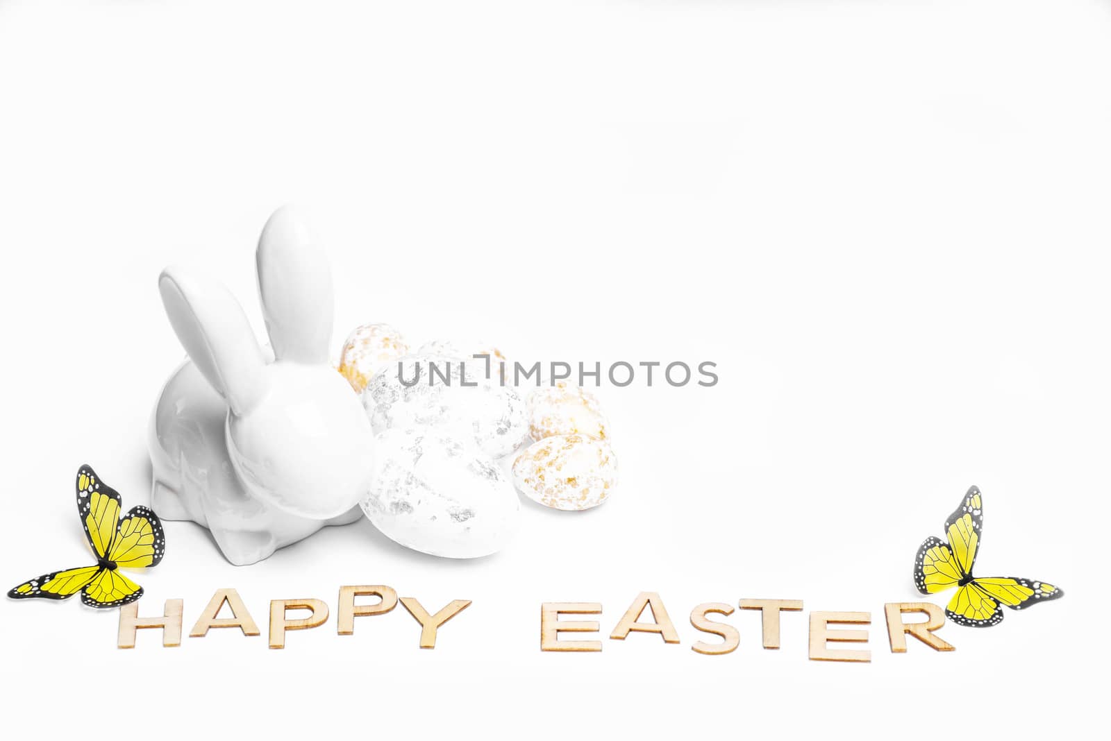 Happy Easter. Easter white bunny on a white background with Easter eggs.Easter greeting card with easter bunny.Happy Easter.