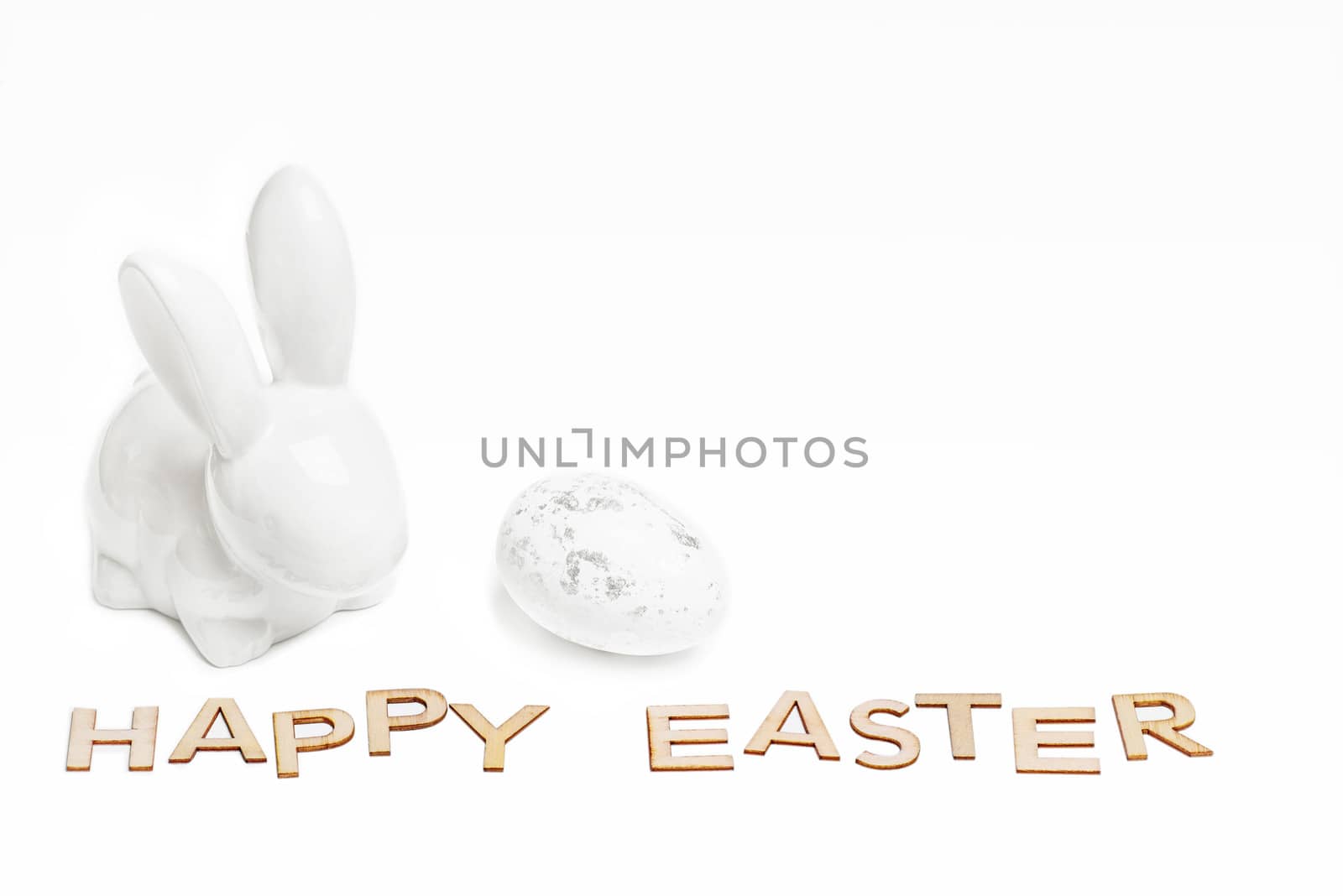 Happy Easter. Easter white bunny on a white background with Easter eggs.Easter greeting card with easter bunny.Happy Easter.