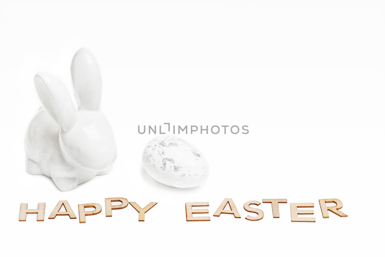 Happy Easter. Easter white bunny on a white background with Easter eggs.Easter greeting card with easter bunny.Happy Easter.