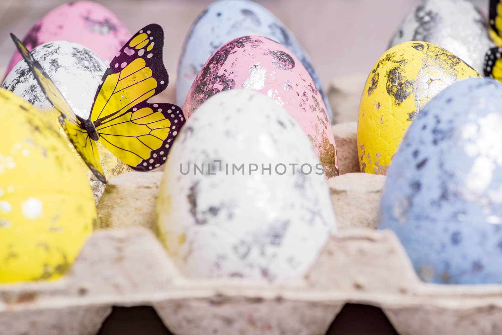 Happy Easter. Multi-colored Easter eggs in the egg cells. Easter card. Close-up.Soft focus.