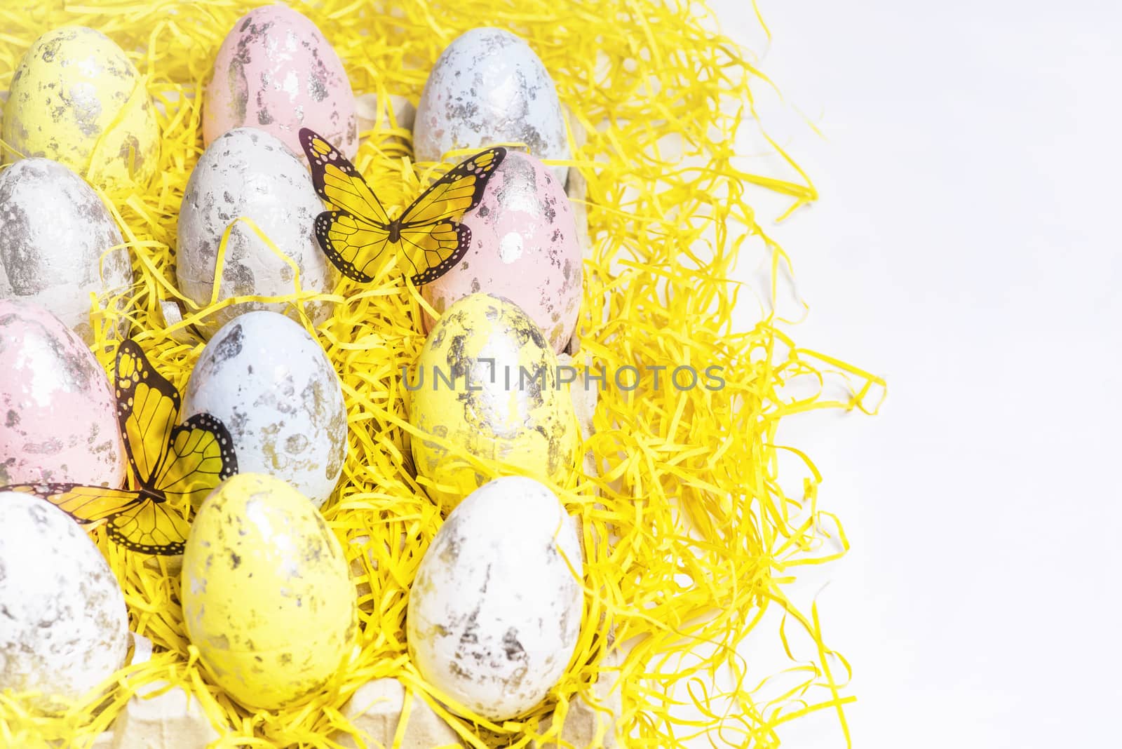 Happy Easter.Multi-colored Easter eggs on a white background with a bunch of wooden letters Happy Easter.