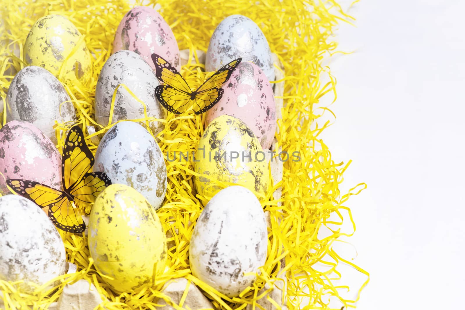 Happy Easter.Multi-colored Easter eggs on a white background with a bunch of wooden letters Happy Easter.