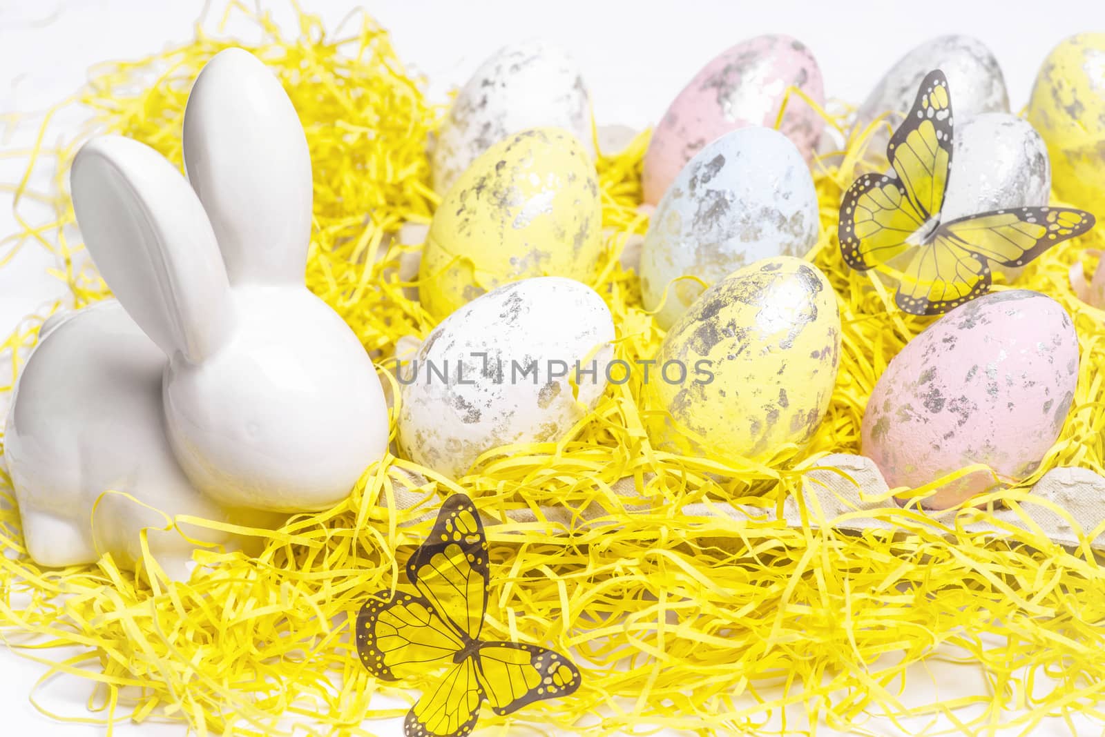 Happy Easter. Easter white bunny on a white background with Easter eggs.Easter greeting card with easter bunny.Happy Easter.