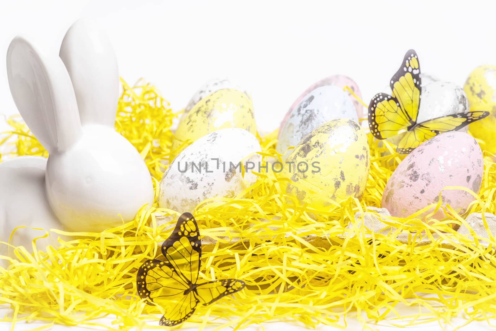 Happy Easter. Easter white bunny on a white background with Easter eggs.Easter greeting card with easter bunny.Happy Easter.
