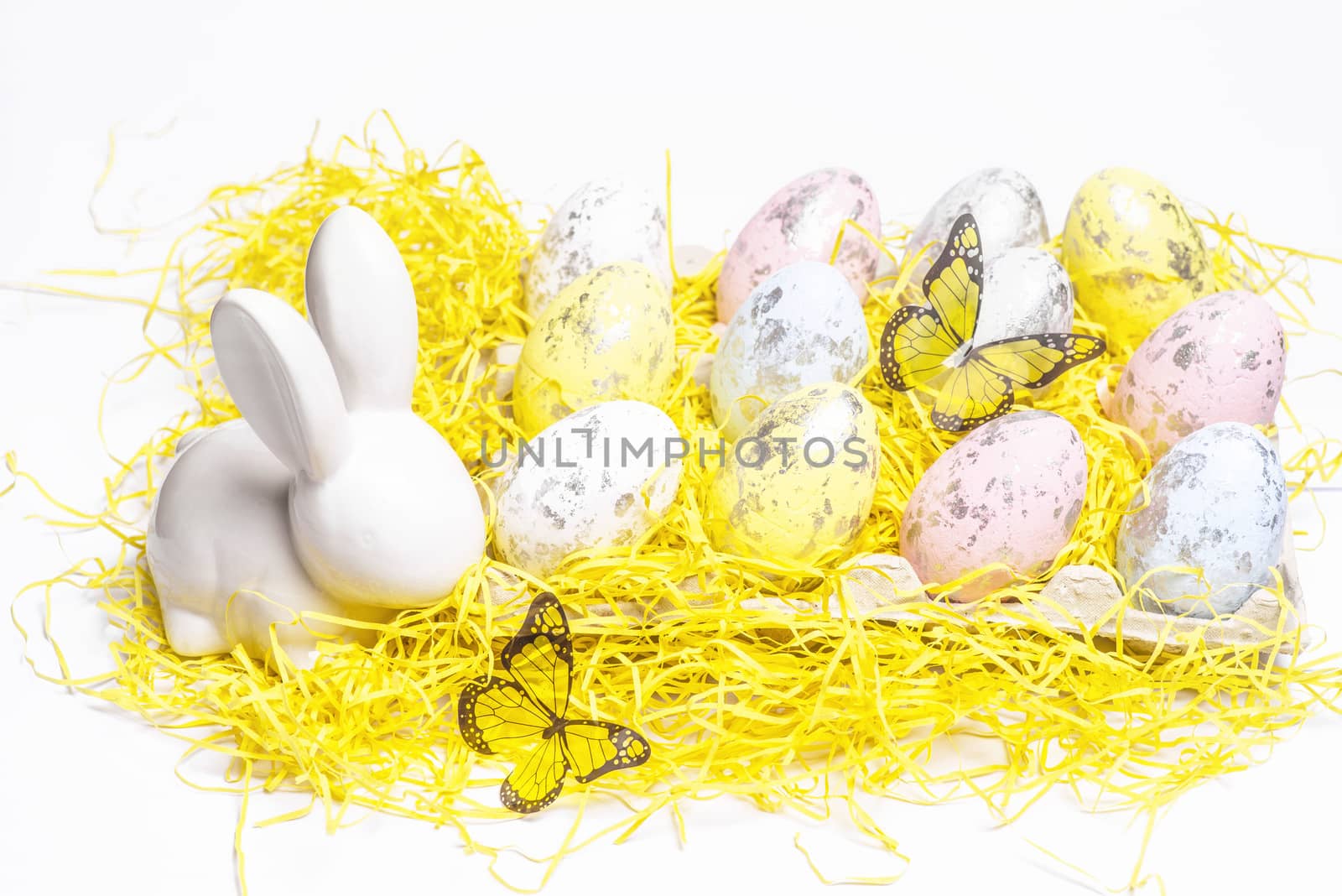 Happy Easter. Easter white bunny on a white background with Easter eggs.Easter greeting card with easter bunny.Happy Easter.
