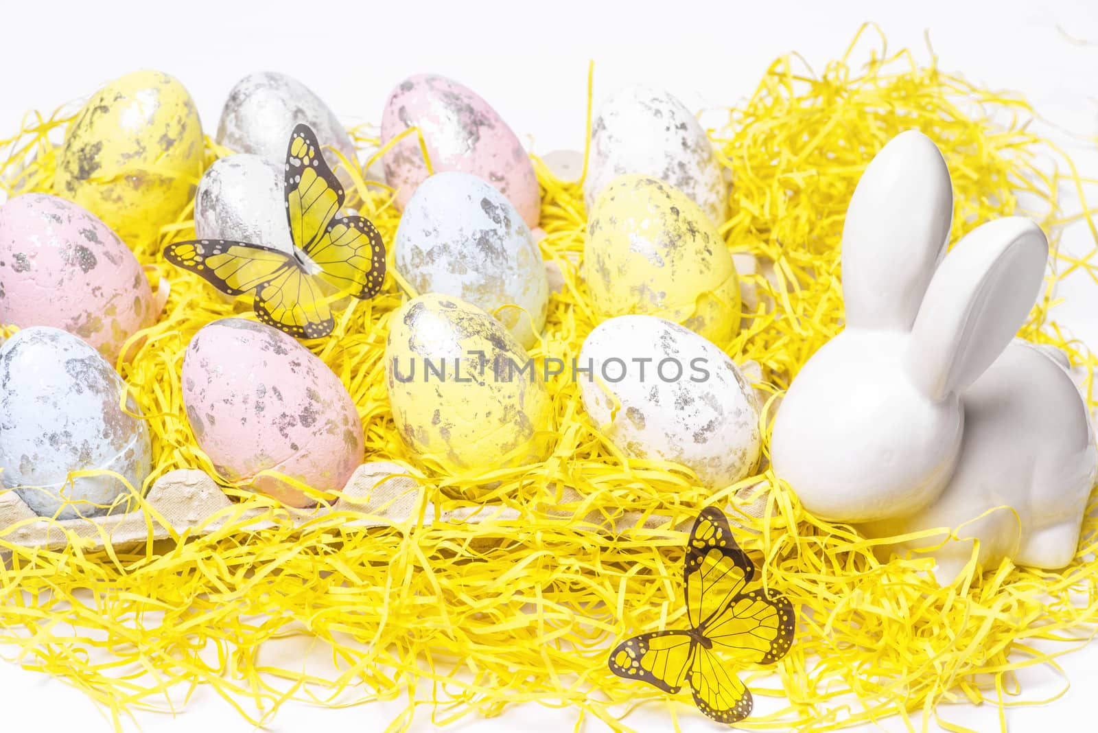Happy Easter. Easter white bunny on a white background with Easter eggs.Easter greeting card with easter bunny.Happy Easter.