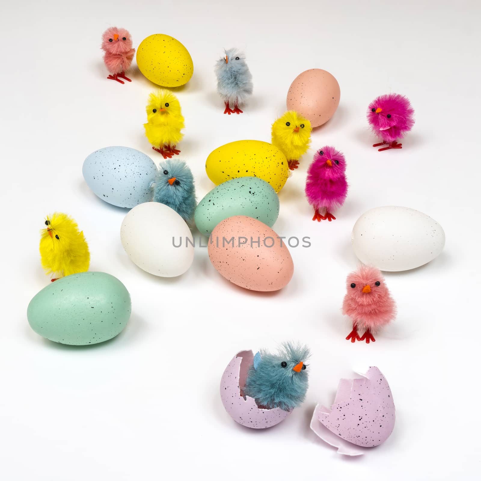 colored easter eggs with little chicks on a white surface