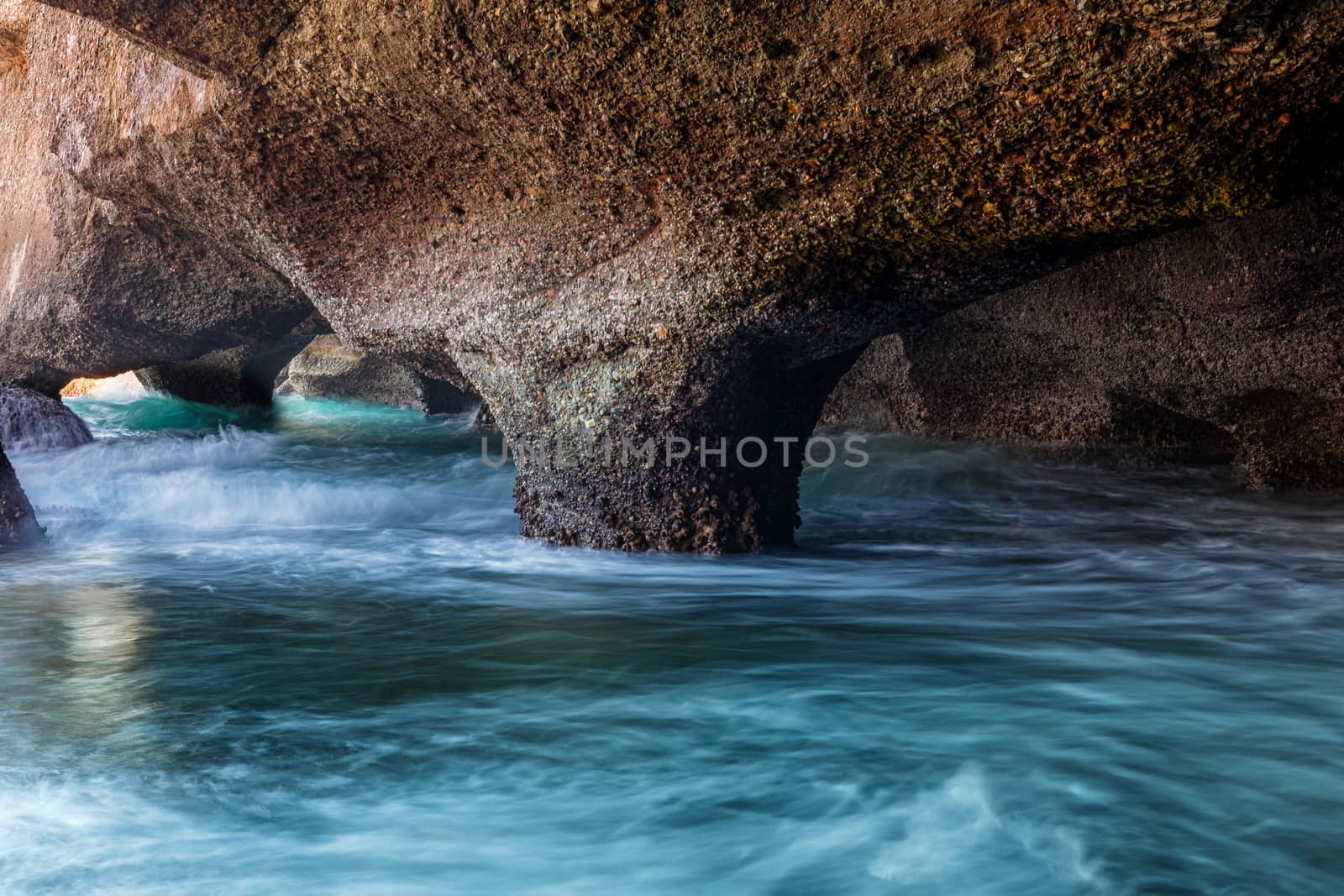 Exploring sea caves along the coastline that have formed and eroded over time into natural arches and columns