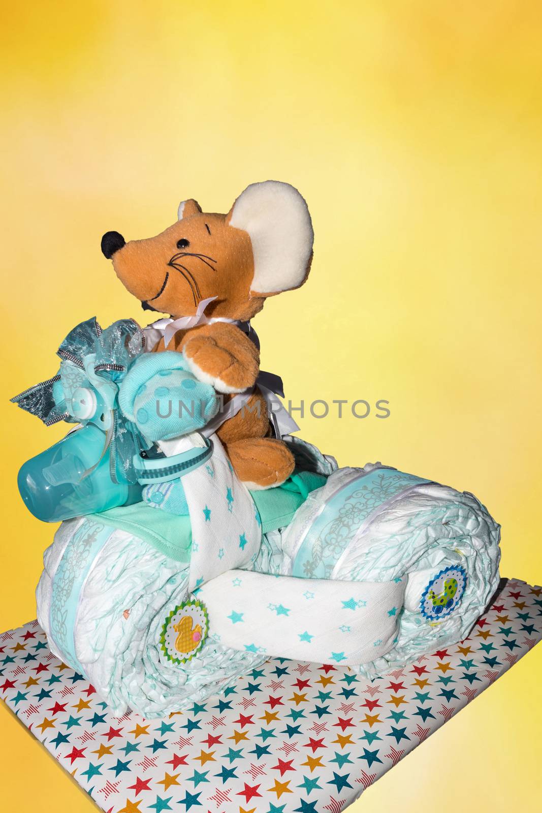 Diaper cake A diaper cake Tricycle with blue ribbons. Gift for the birth of a child