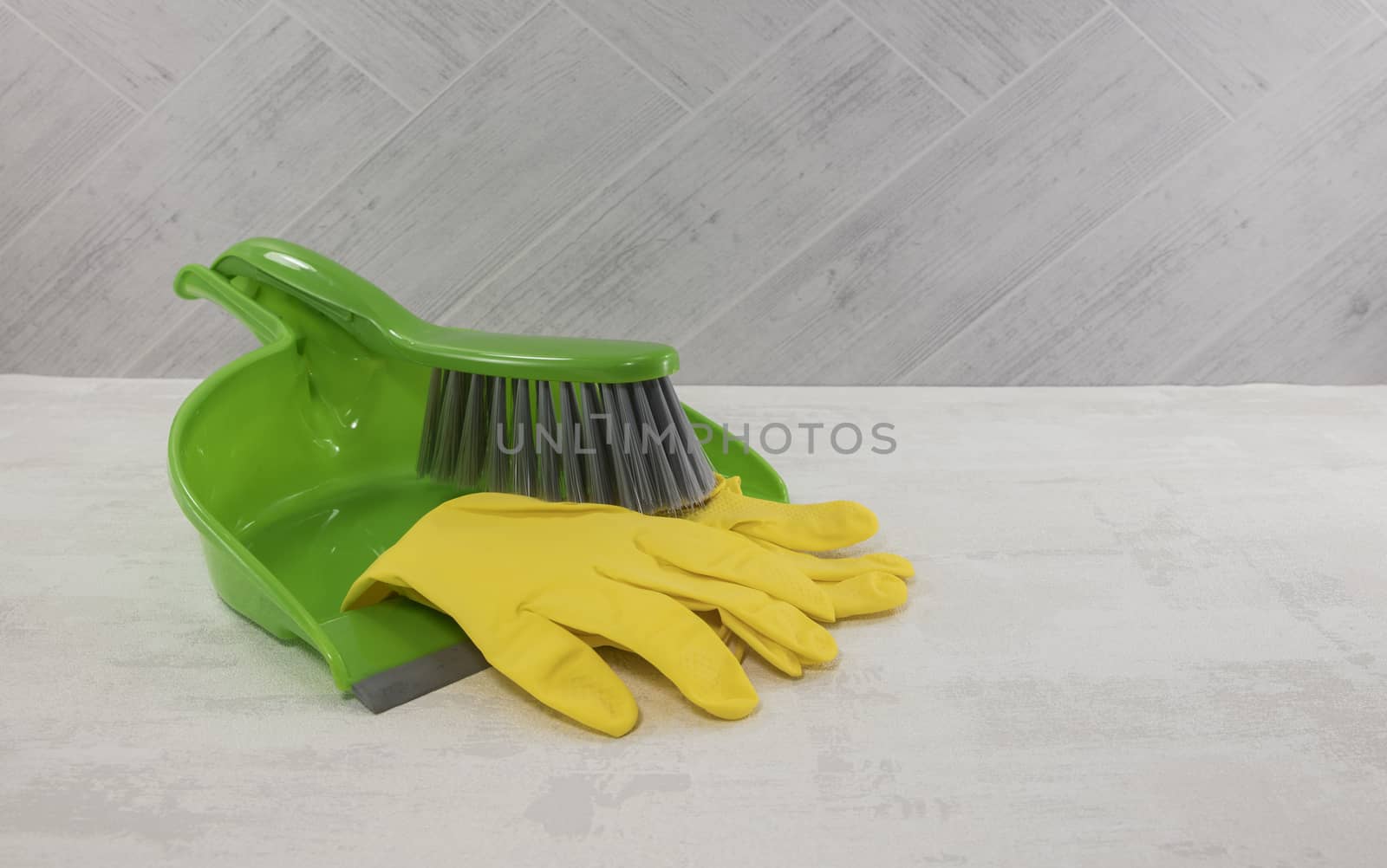 cleaning tools as dustpan and gloves in green and yellow 