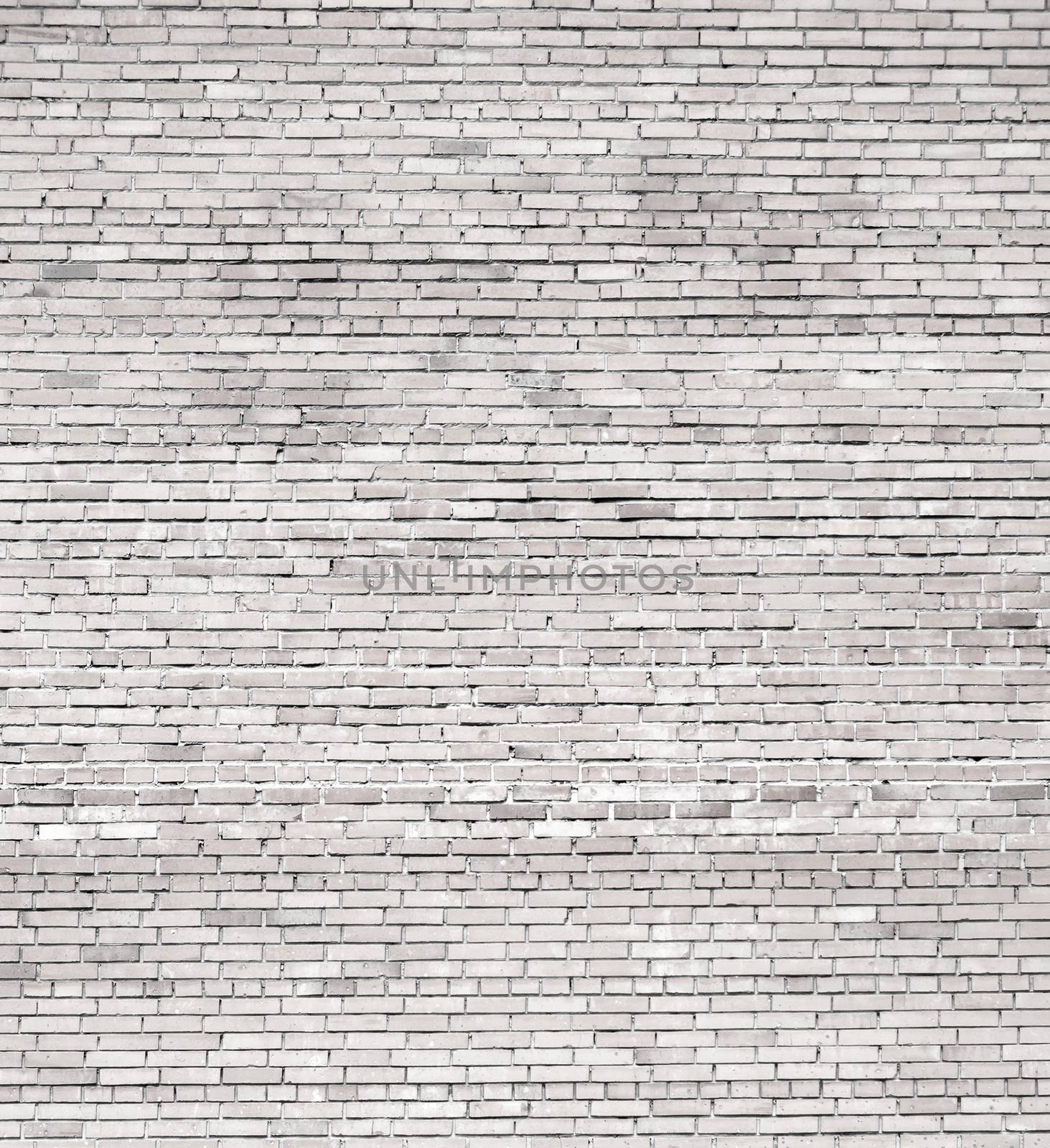Background of the large wall of white weathered bricks
