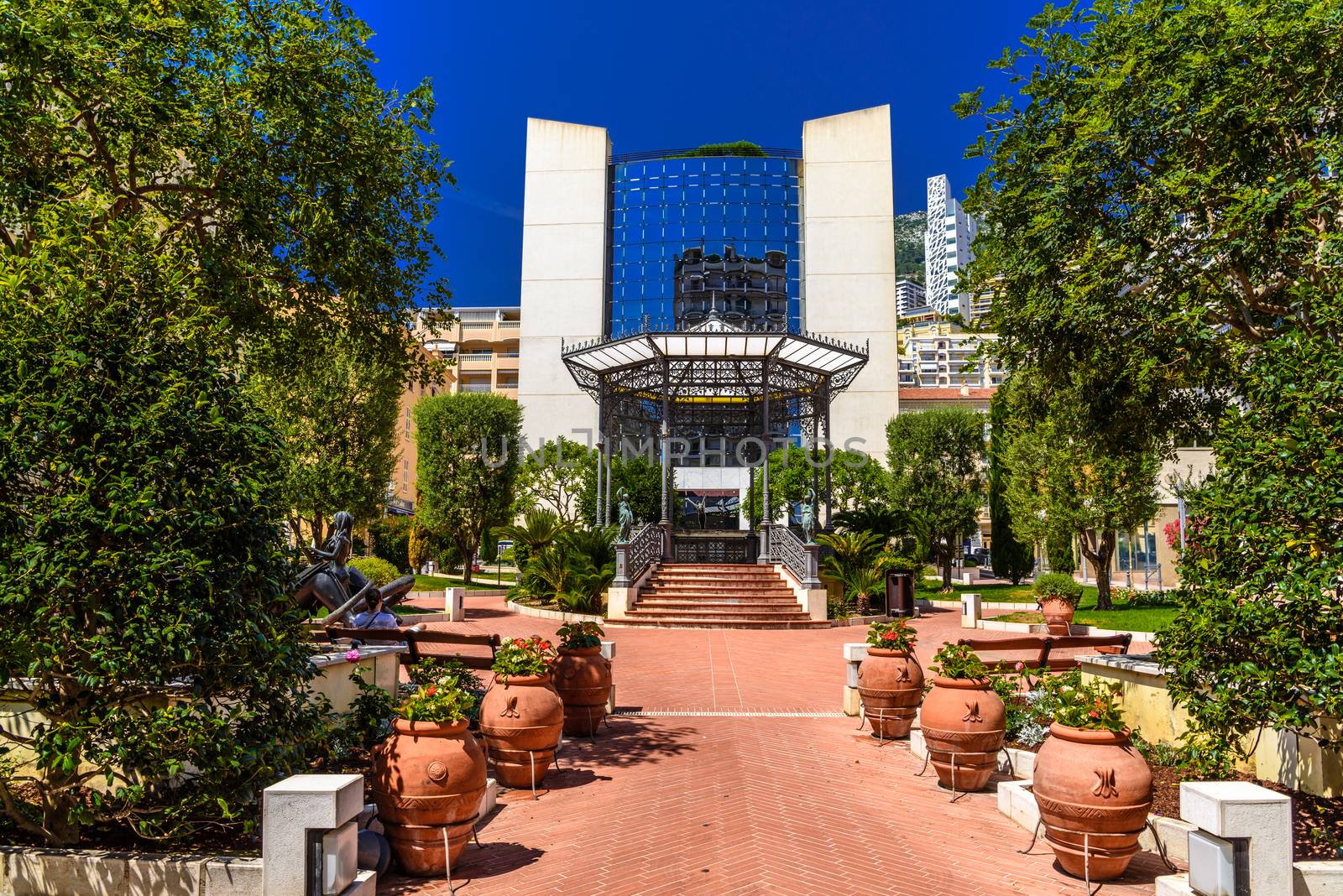 City center with glass building, vases and trees, La Condamine, Monte-Carlo, Monaco, Cote d'Azur, French Riviera.