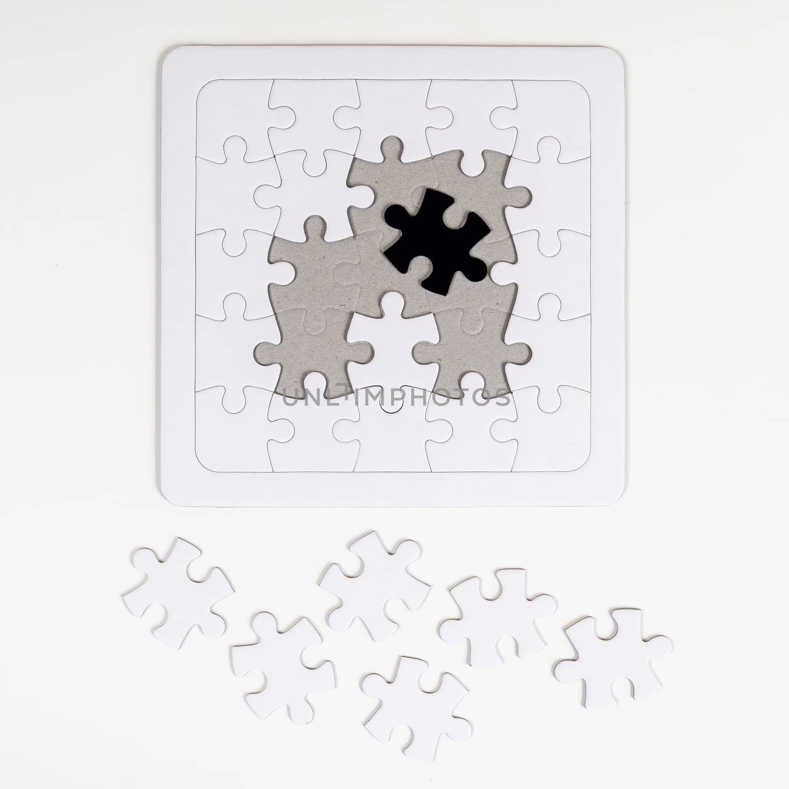 the incomplete puzzle with a black piece