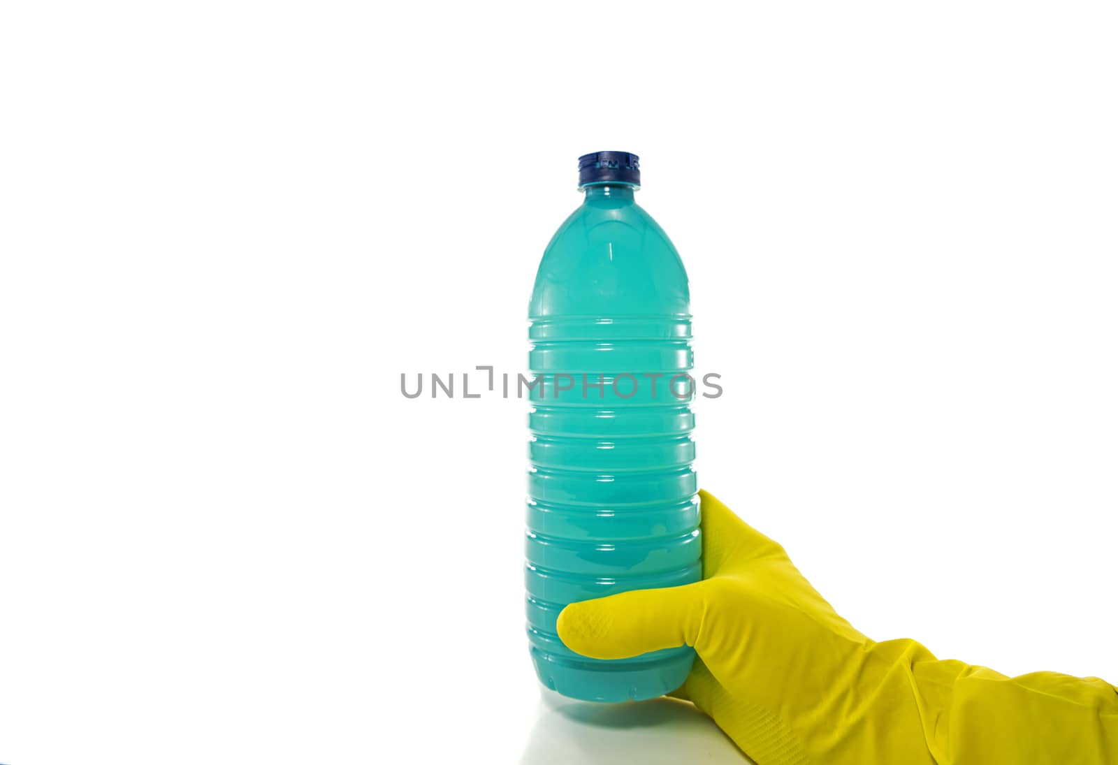 hand with yellow household glove holding a plastic bottle of detergent on a white background