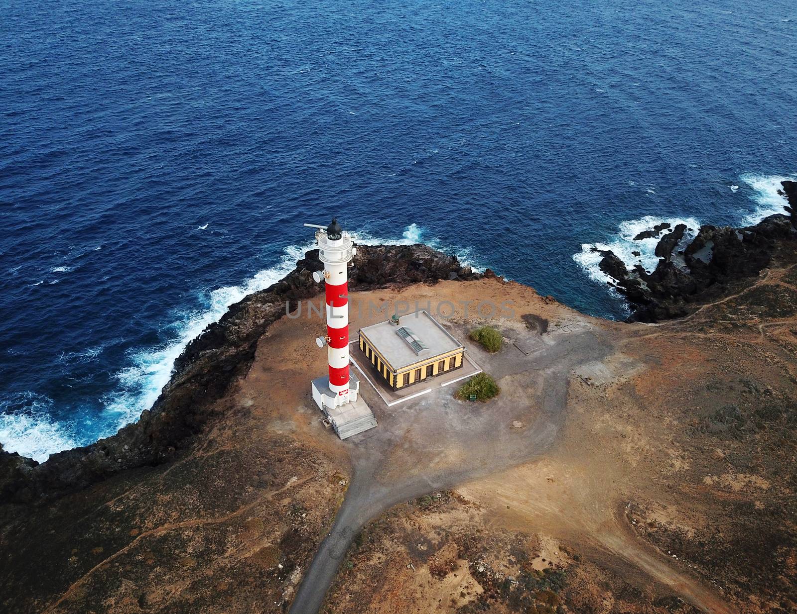 Aerial view of the lighthouse Faro de Rasca on The Tenerife, Canary Islands, Spain. Wild Coast of the Atlantic Ocean