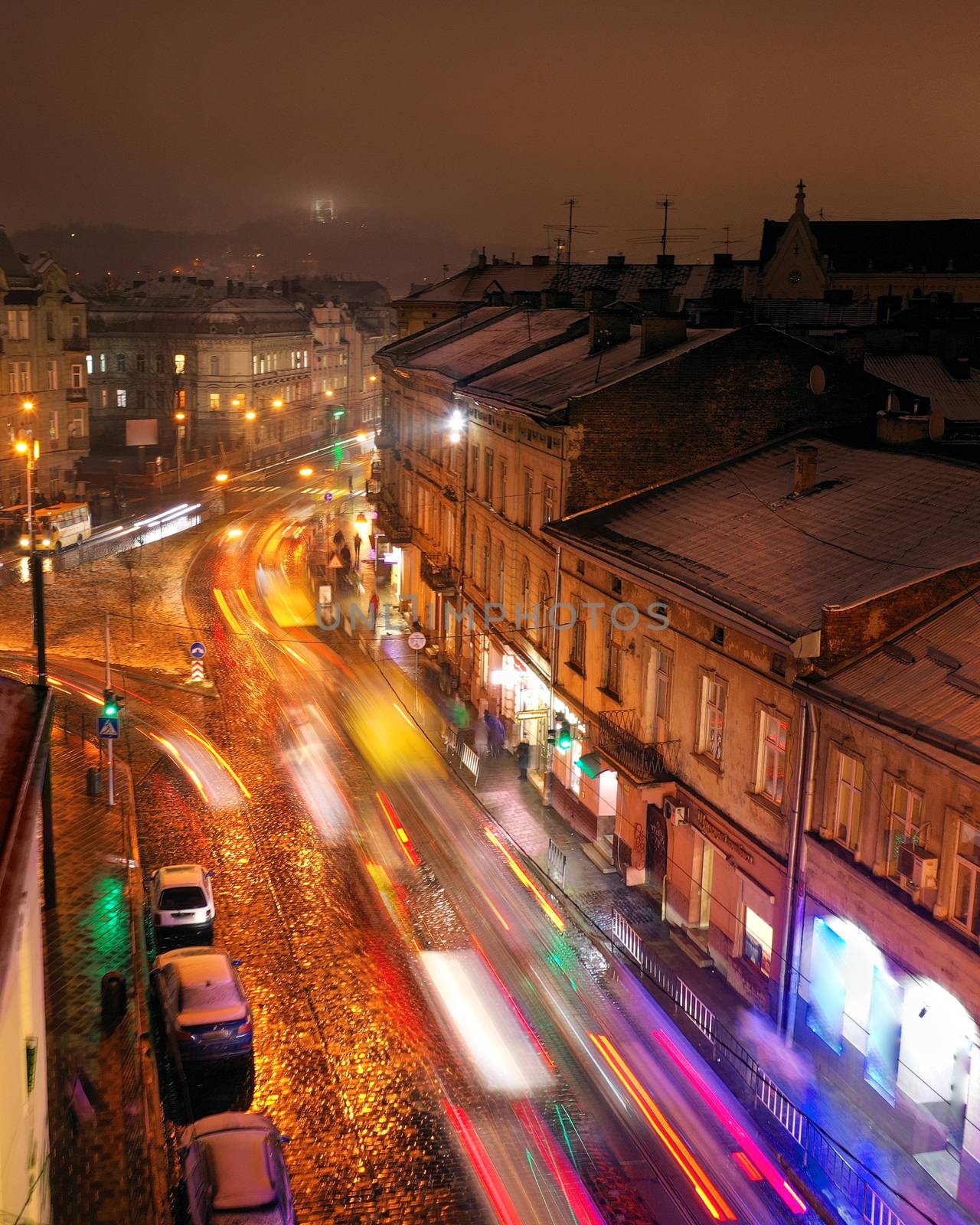Aerial view of one of the central streets of Lviv at night. Blurred car lights