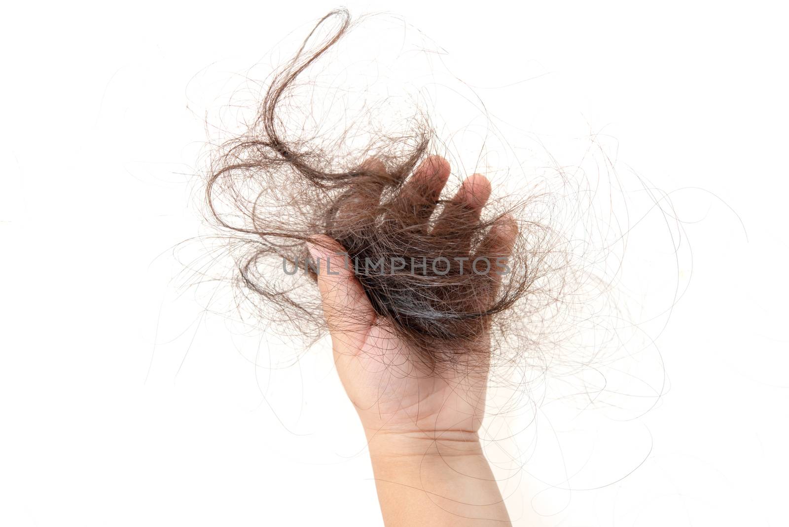 Child hand grabbing lost hair, isolated on white background.