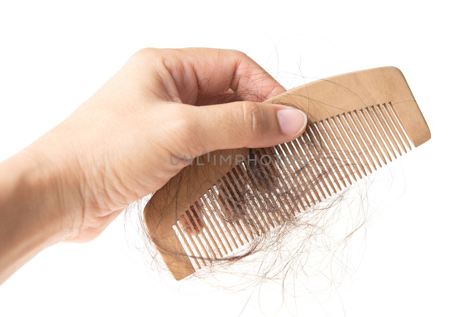 Hand holding comb with lost hair  by szefei