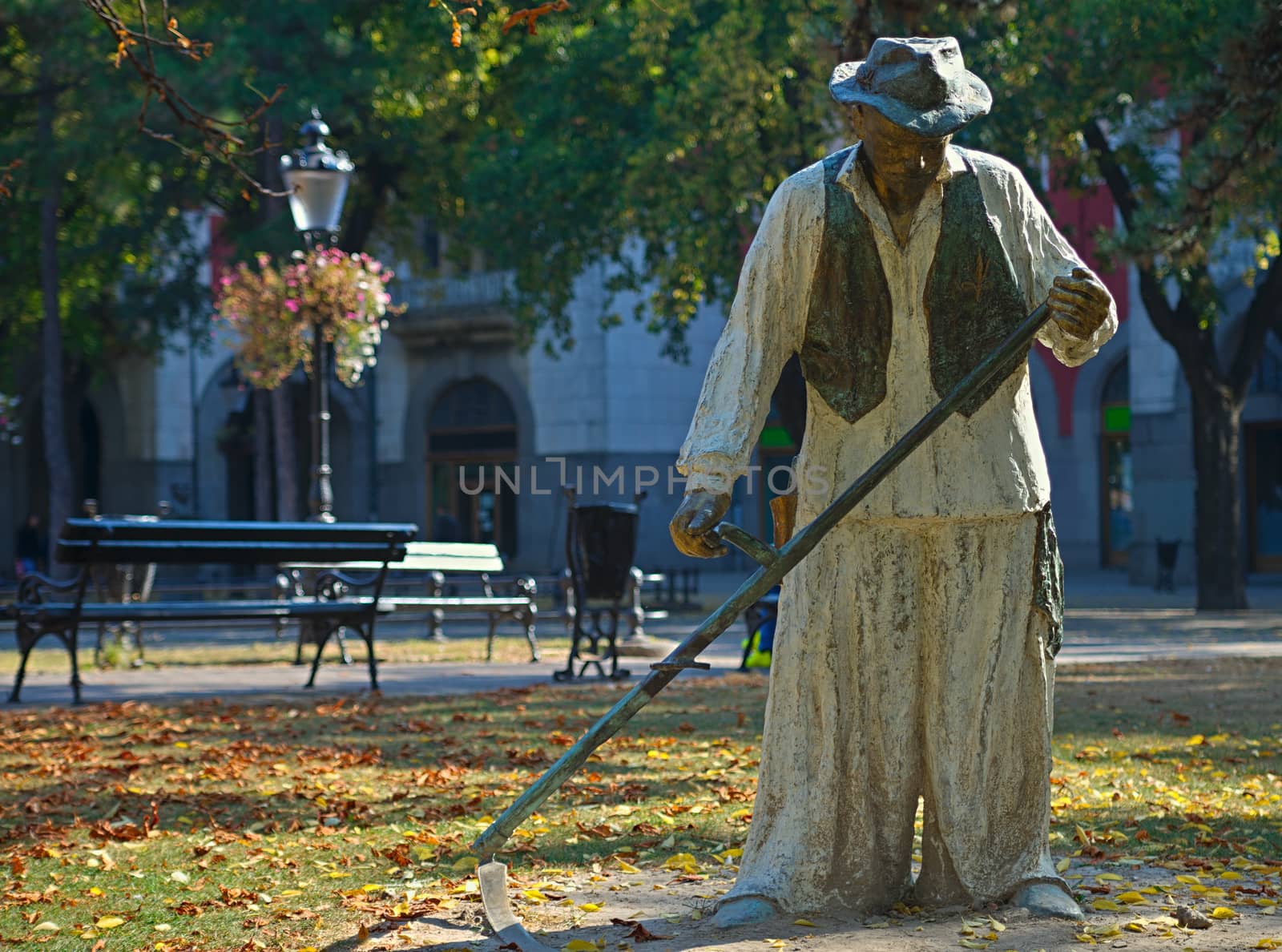 Statue of a traditional scythe man on main square in Subotica, Serbia by sheriffkule