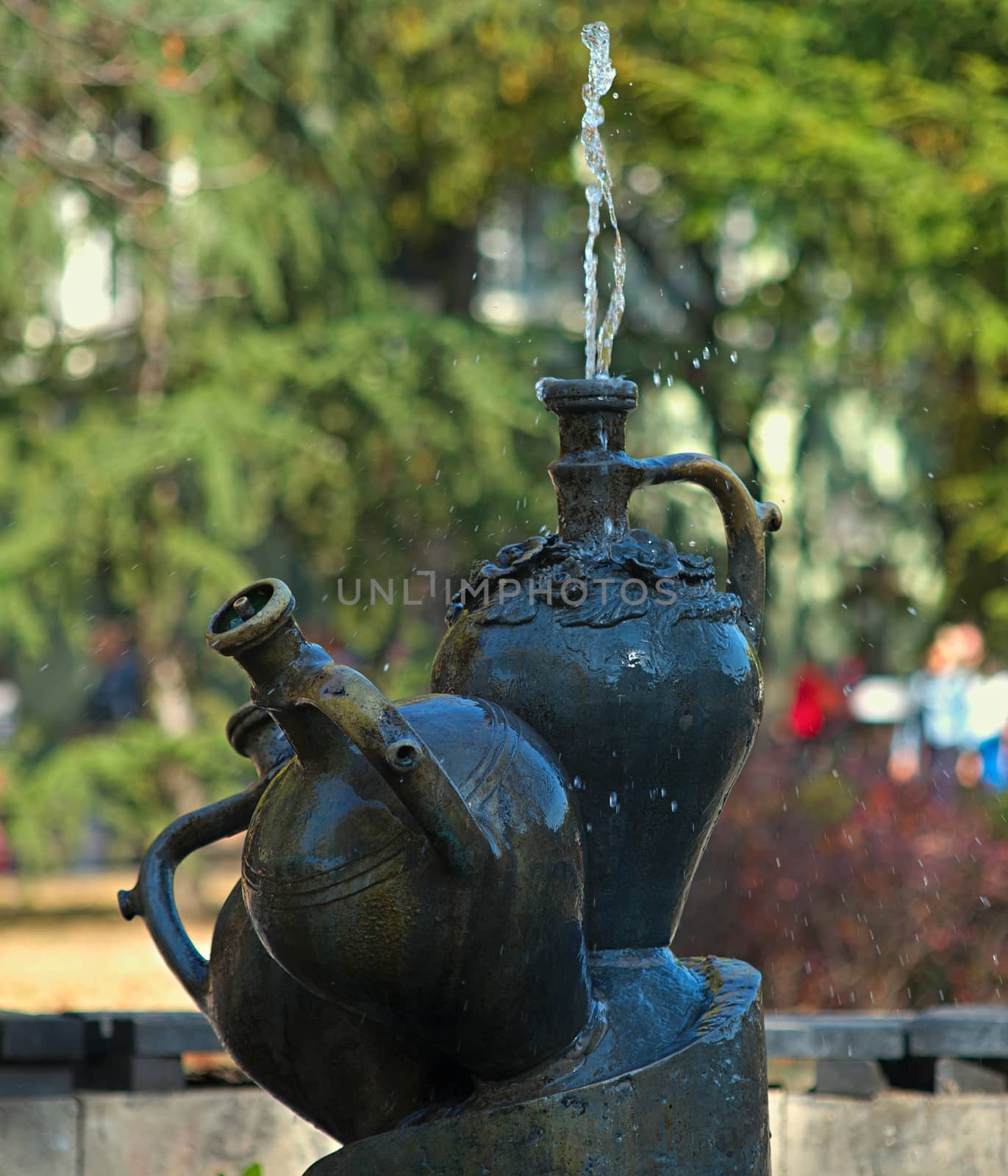 Fountains made as a marble pots with water spraying from one of them