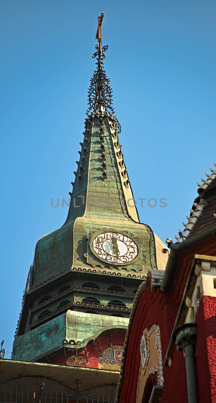 Top of the tower with a clock on a catholic church by sheriffkule