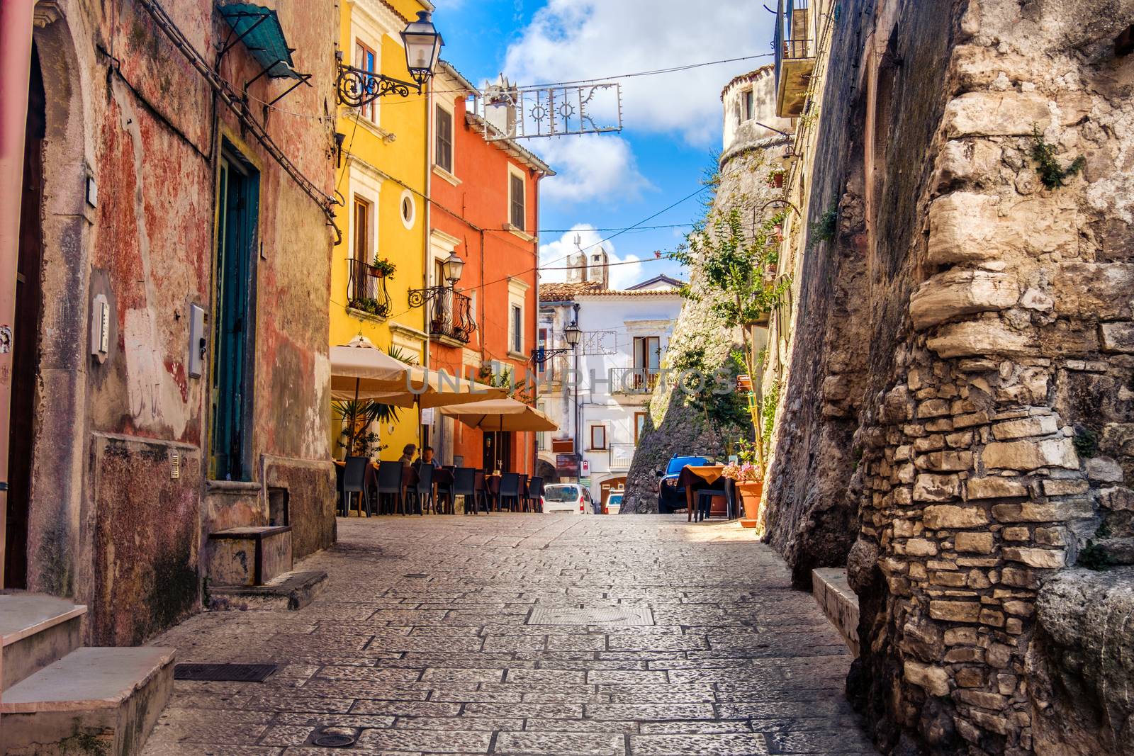 colorful south italy village alley in Apulia in the town of Vico by LucaLorenzelli