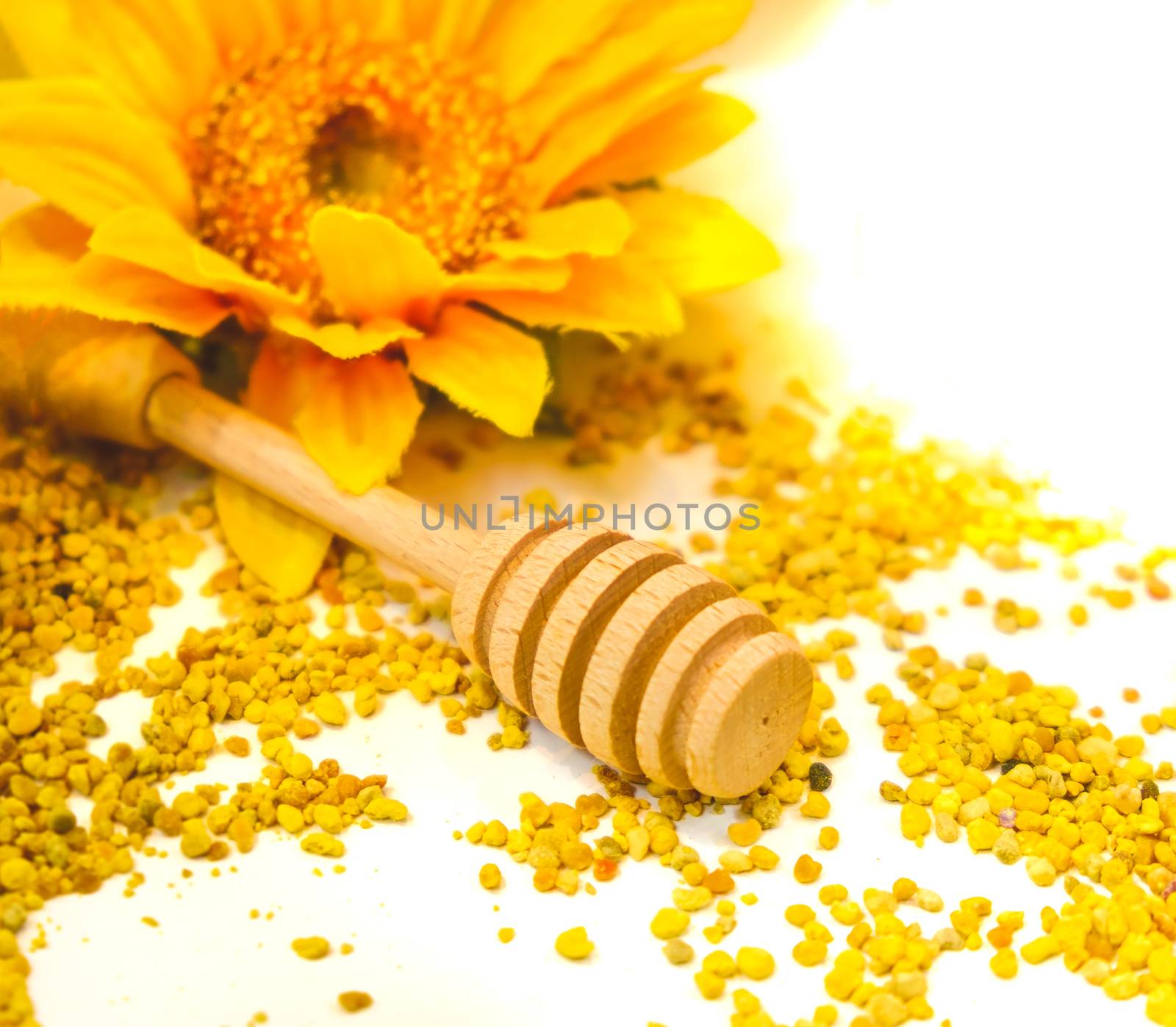 propolis granules honey dripper background drizzle wooden spoon by LucaLorenzelli